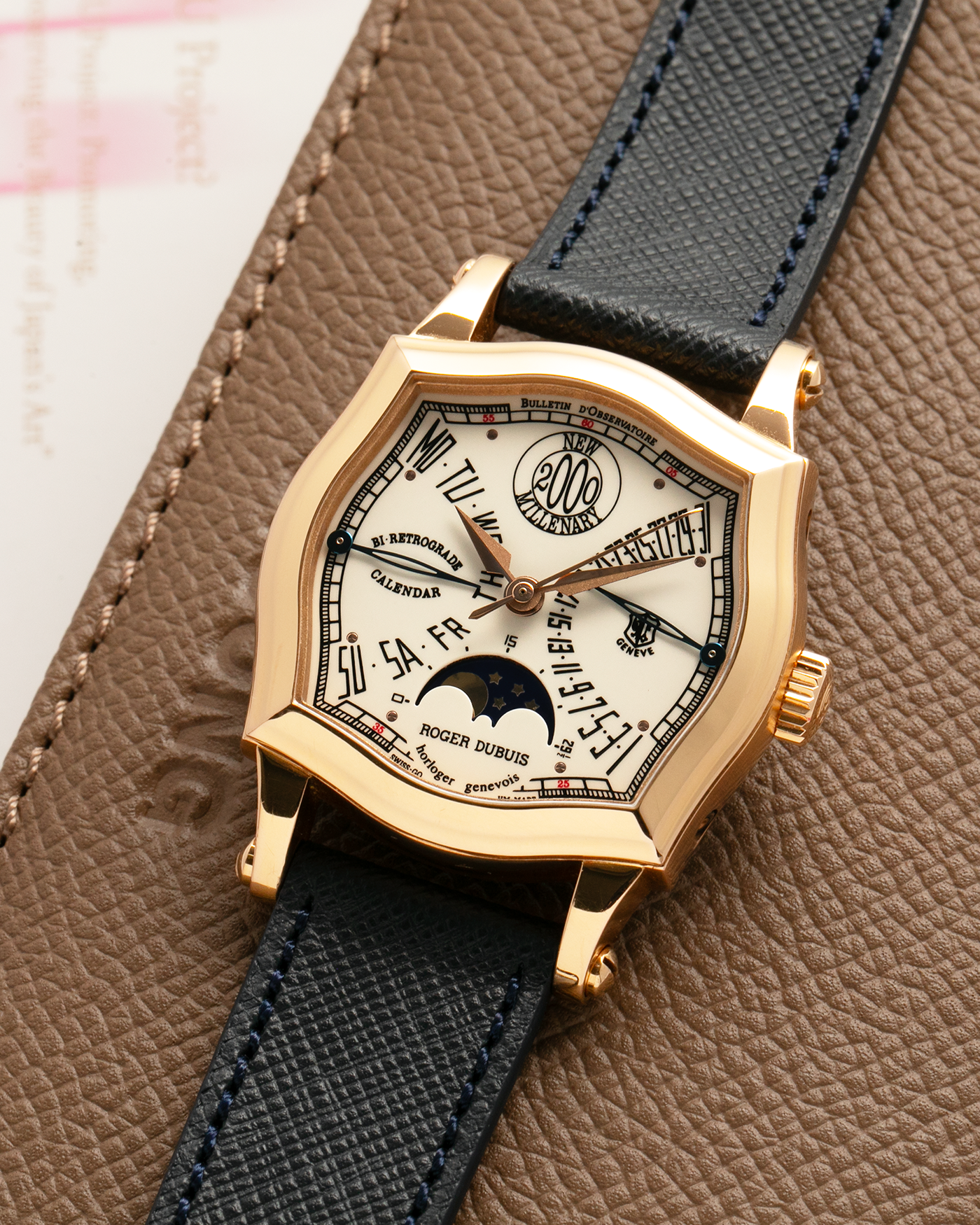 Brand: Roger Dubuis
Year: 2000
Model: Sympathie 37 2000 New Millenary
Material: 18k Rose Gold
Movement: Roger Dubuis Cal. 5740
Case Dimensions: 34mm Diameter 11mm Thickness
Lug Width: 18mm
Strap: Molequin Navy Blue Textured Calf Leather Strap with Signed 18k Rose Gold Tang Buckle