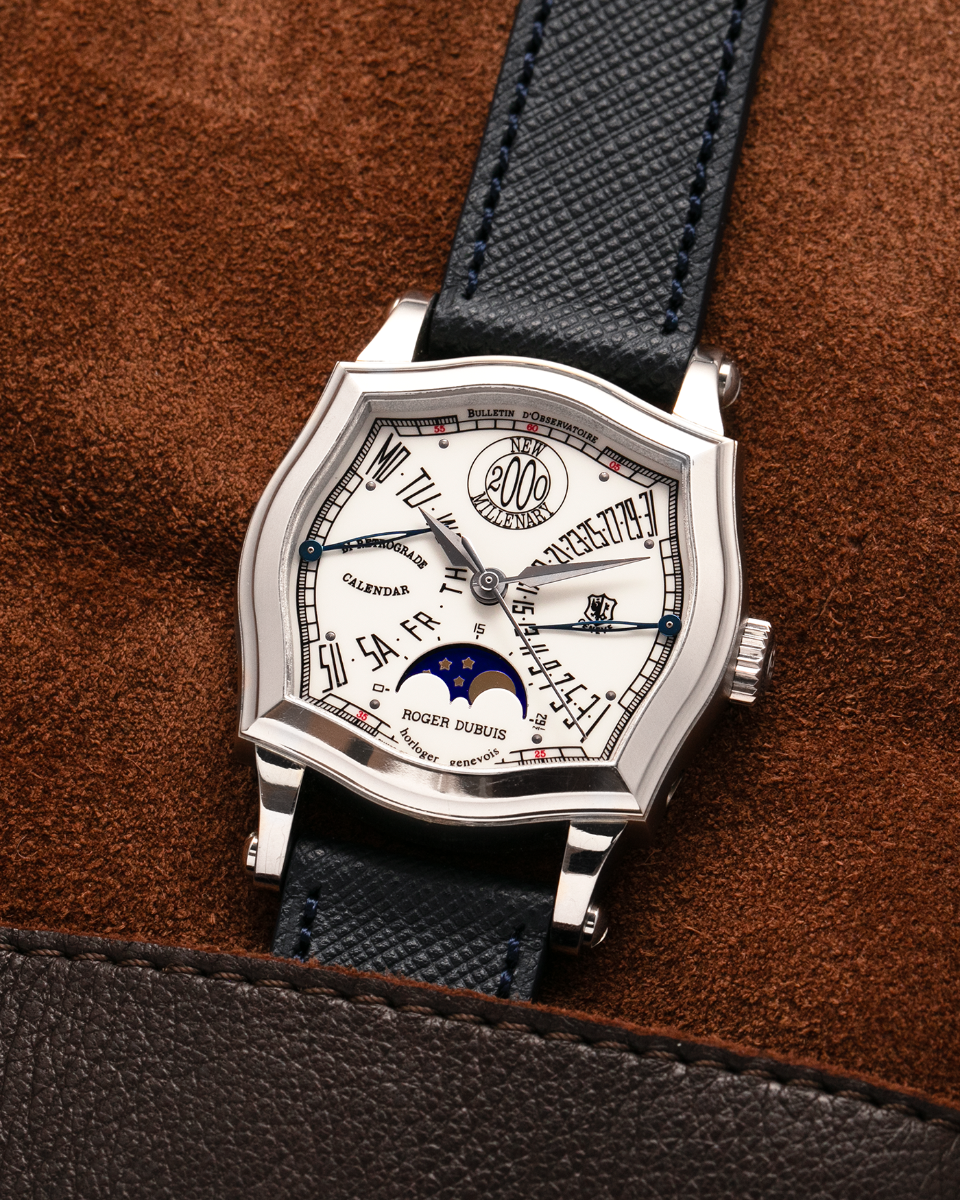 Brand: Roger Dubuis
Year: 2000
Model: Sympathie 37 Bi-retrograde Calendar 2000 New Millenary
Material: 18-carat White Gold
Movement: Roger Dubuis Cal. 5840
Case Dimensions: 34mm Diameter, 11mm Thickness
Lug Width: 18mm
Strap: Molequin Navy Blue Textured Calf Leather Strap with Signed 18-carat White Gold Tang Buckle
