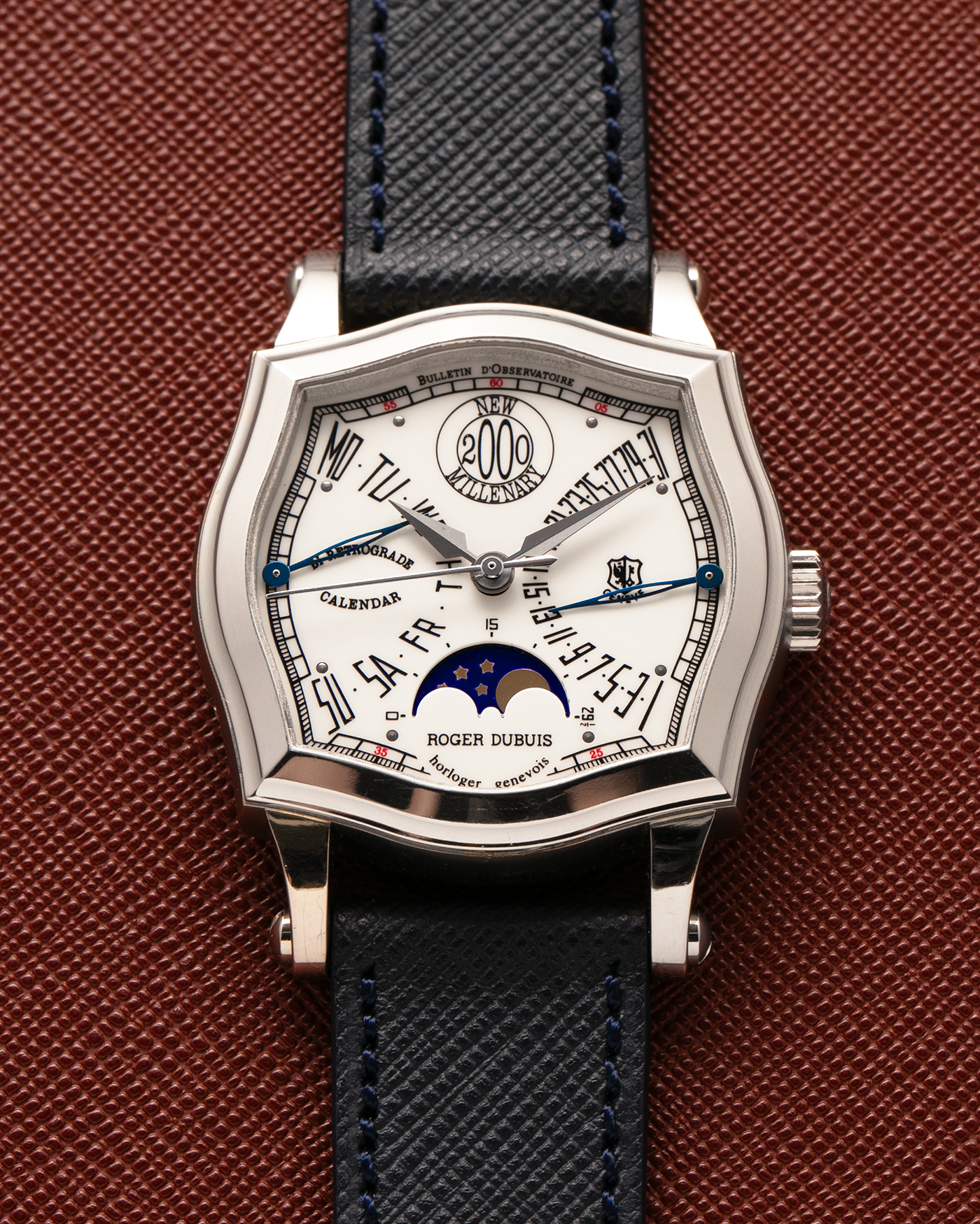 Brand: Roger Dubuis
Year: 2000
Model: Sympathie 37 Bi-retrograde Calendar 2000 New Millenary
Material: 18-carat White Gold
Movement: Roger Dubuis Cal. 5840
Case Dimensions: 34mm Diameter, 11mm Thickness
Lug Width: 18mm
Strap: Molequin Navy Blue Textured Calf Leather Strap with Signed 18-carat White Gold Tang Buckle