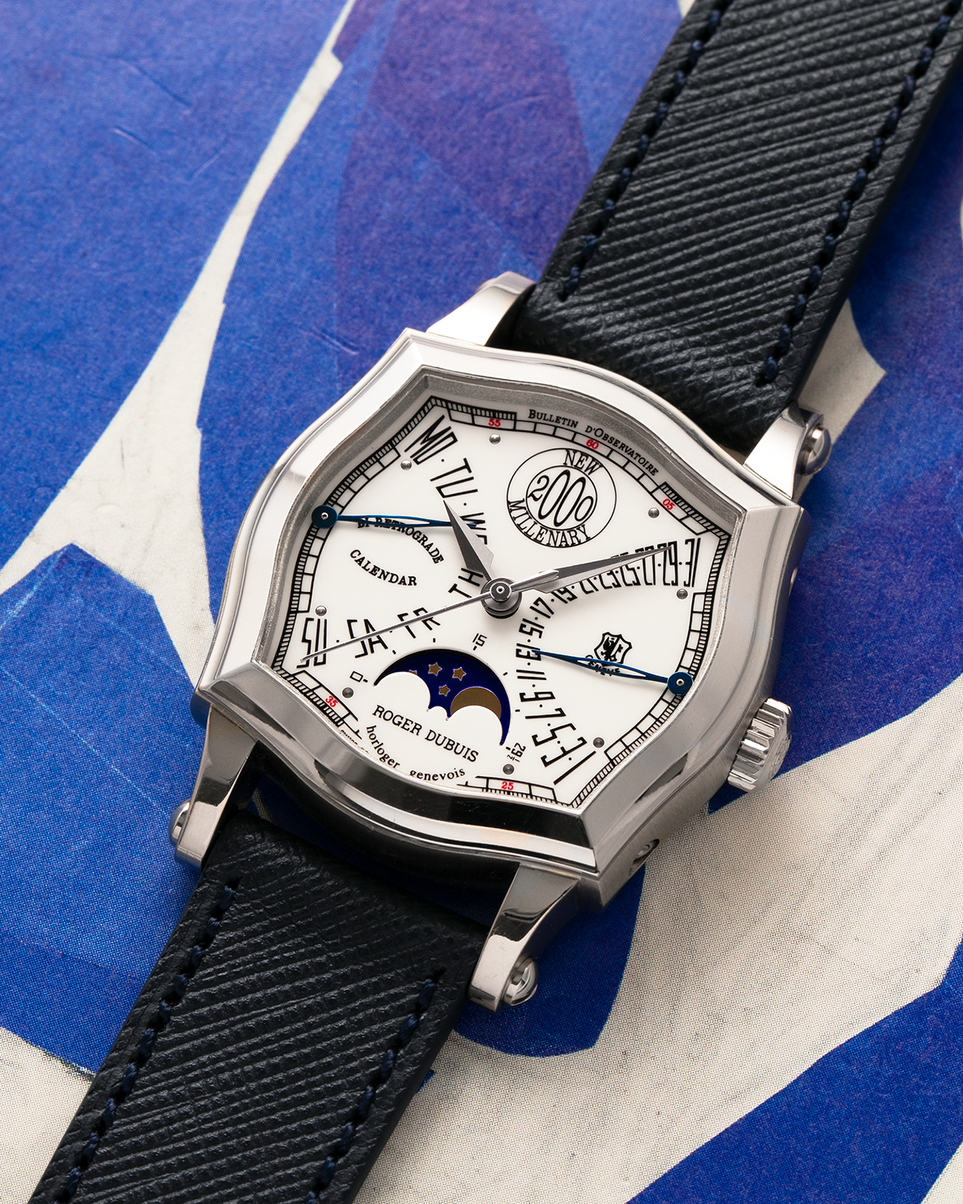Brand: Roger Dubuis
Year: 2000
Model: Sympathie 37 Bi-retrograde Calendar 2000 New Millenary
Material: 18-carat White Gold
Movement: Roger Dubuis Cal. 5840
Case Dimensions: 34mm Diameter, 11mm Thickness
Lug Width: 18mm
Strap: Molequin Navy Blue Textured Calf Leather Strap with Signed 18-carat White Gold Tang Buckle