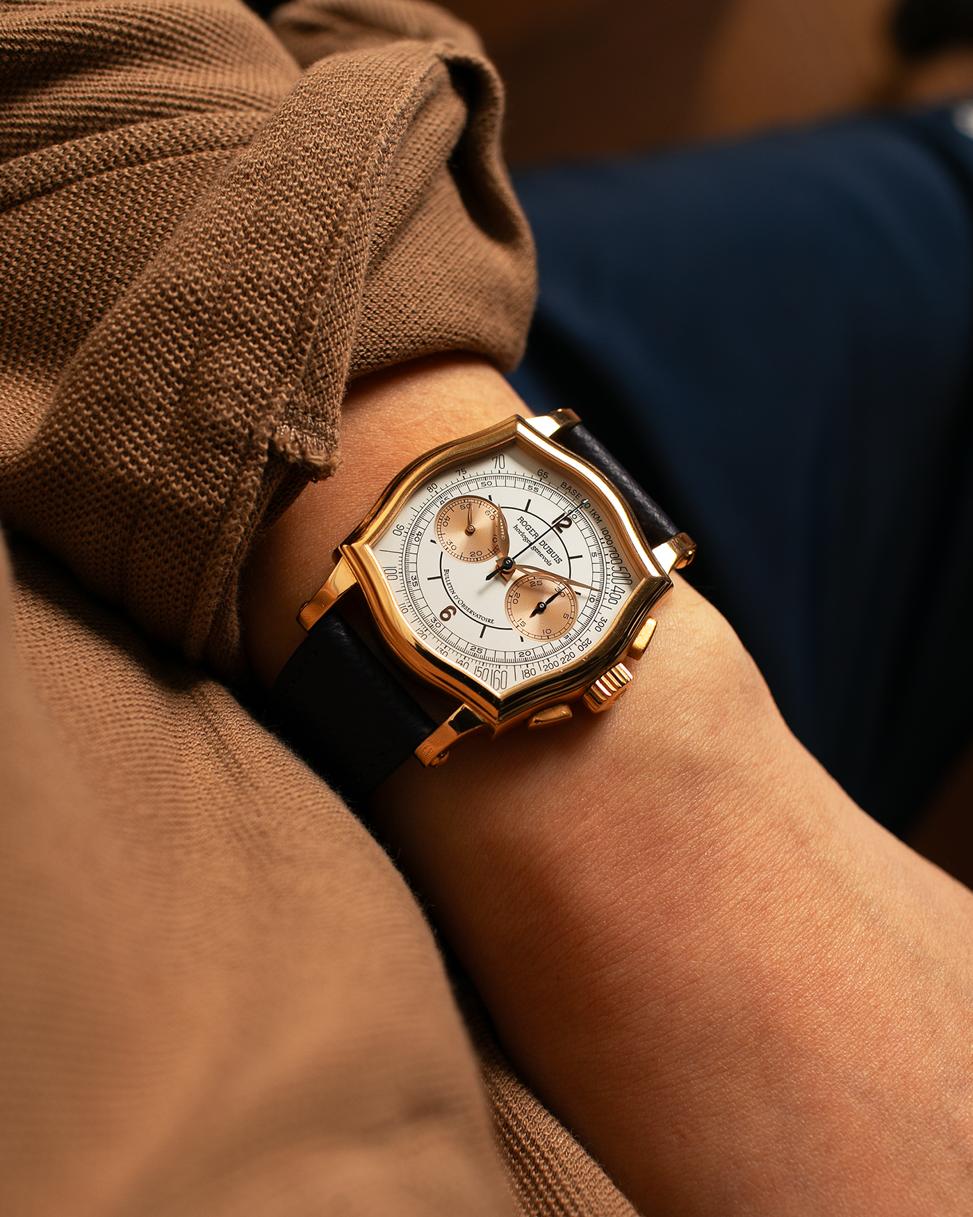 Brand: Roger Dubuis
Year: Late 1990’s/2000’s
Model: Sympathie 37 Perpetual Chronograph
Material: 18k Rose Gold
Movement: Cal RD56 / Lemania 2310
Case Diameter: 37mm
Strap: Nostime Blue Textured Calf Strap and Roger Dubuis 18k Rose Gold Tang Buckle