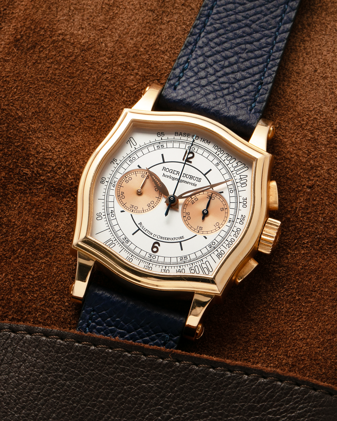 Brand: Roger Dubuis
Year: Late 1990’s/2000’s
Model: Sympathie 37 Perpetual Chronograph
Material: 18k Rose Gold
Movement: Cal RD56 / Lemania 2310
Case Diameter: 37mm
Strap: Nostime Blue Textured Calf Strap and Roger Dubuis 18k Rose Gold Tang Buckle