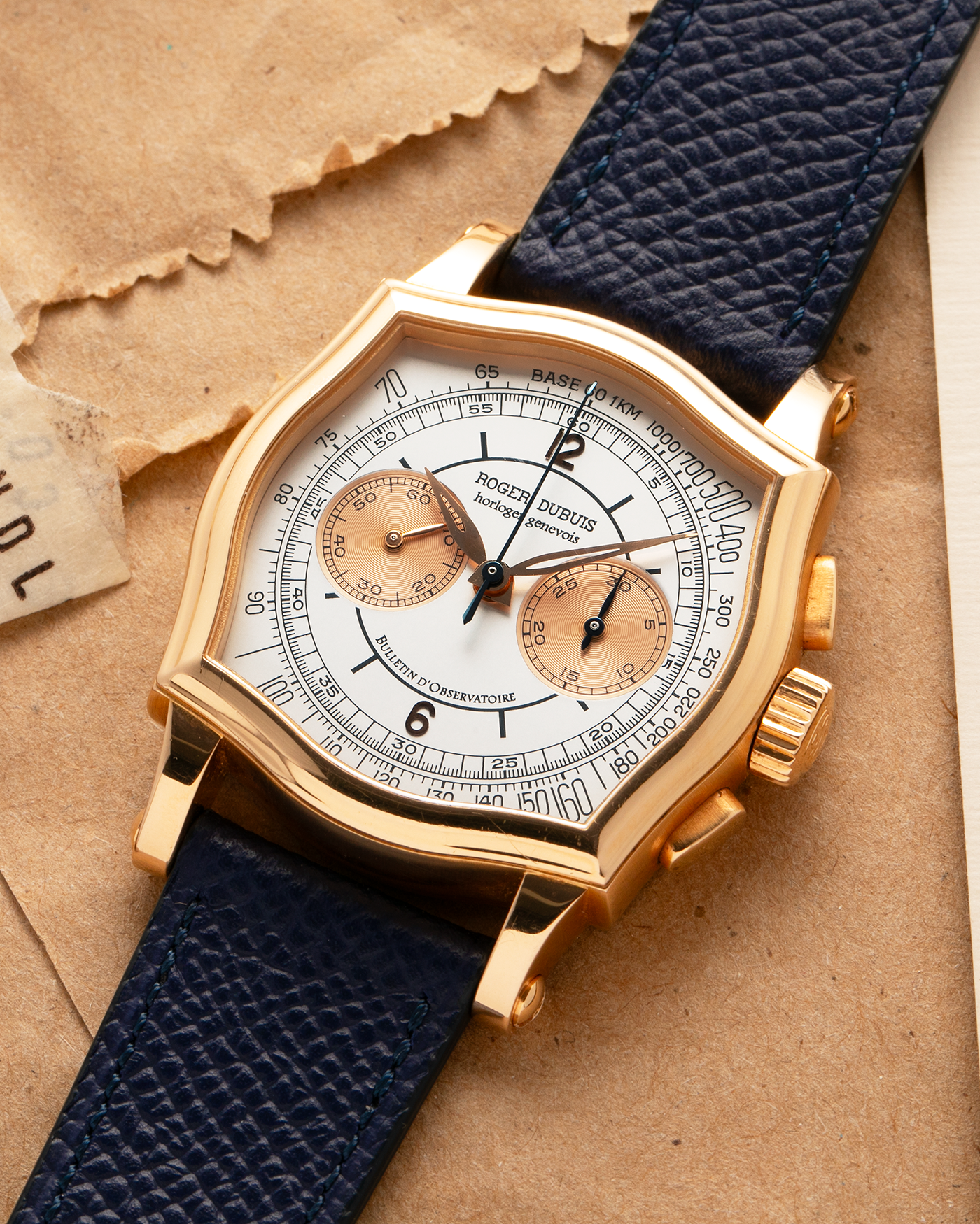 Brand: Roger Dubuis
Year: Late 1990’s/2000’s
Model: Sympathie 37 Perpetual Chronograph
Material: 18k Rose Gold
Movement: Cal RD56 / Lemania 2310
Case Diameter: 37mm
Strap: Nostime Blue Textured Calf Strap and Roger Dubuis 18k Rose Gold Tang Buckle