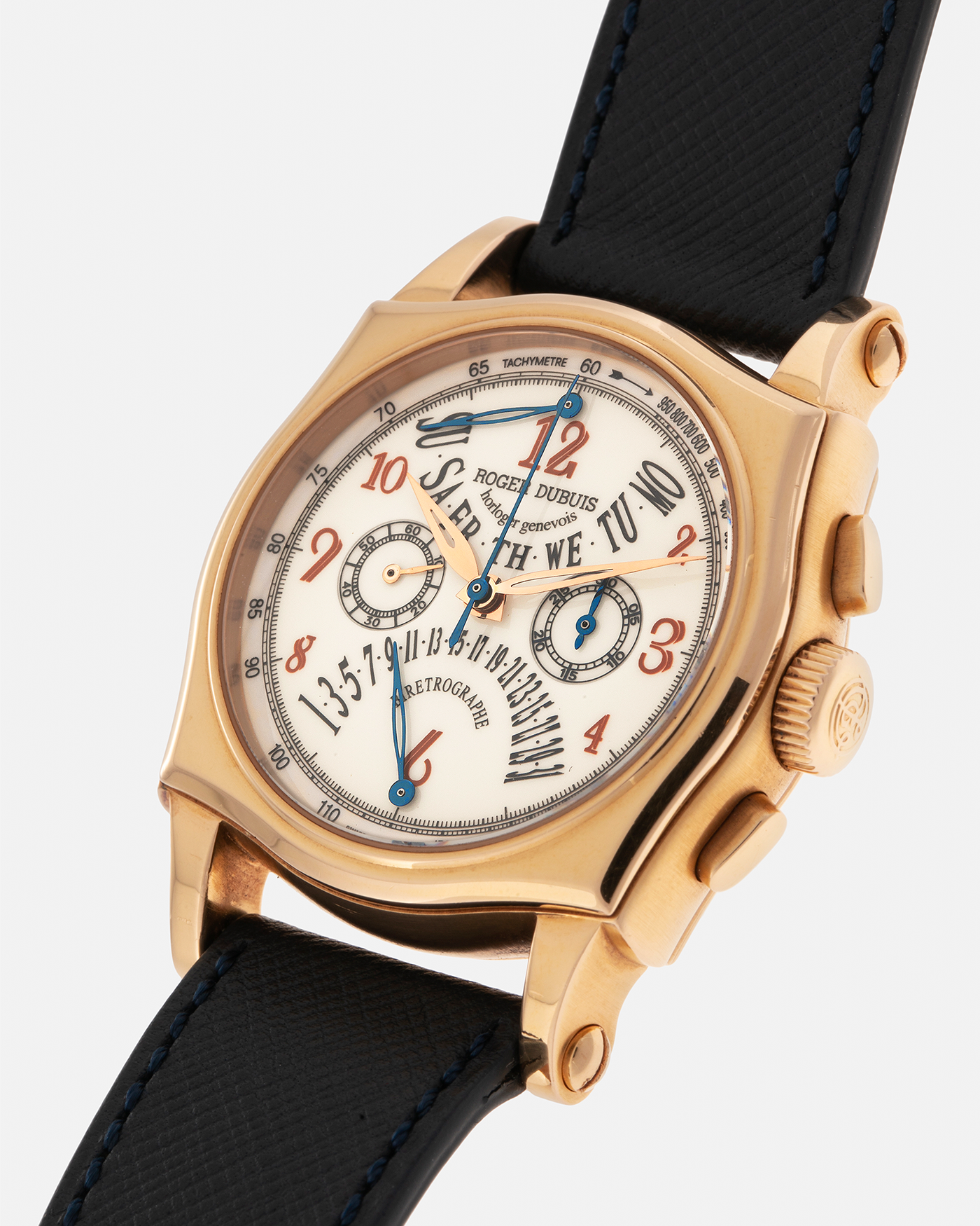 Brand: Roger Dubuis
Year: 2000s
Model: Sympathie 40 Biretrograde Chronograph
Material: 18-carat Yellow Gold
Movement: Roger Dubuis Cal. RD 5630 (Based on the Lemania Cal. 2310), Manual-Winding
Case Dimensions: 40mm x 12.25mm (Lug-to-Lug 47mm)
Lug Width: 22mm
Strap: Molequin Navy Blue Textured Calf Leather Strap with Signed 18-carat Yellow Gold Tang Buckle
