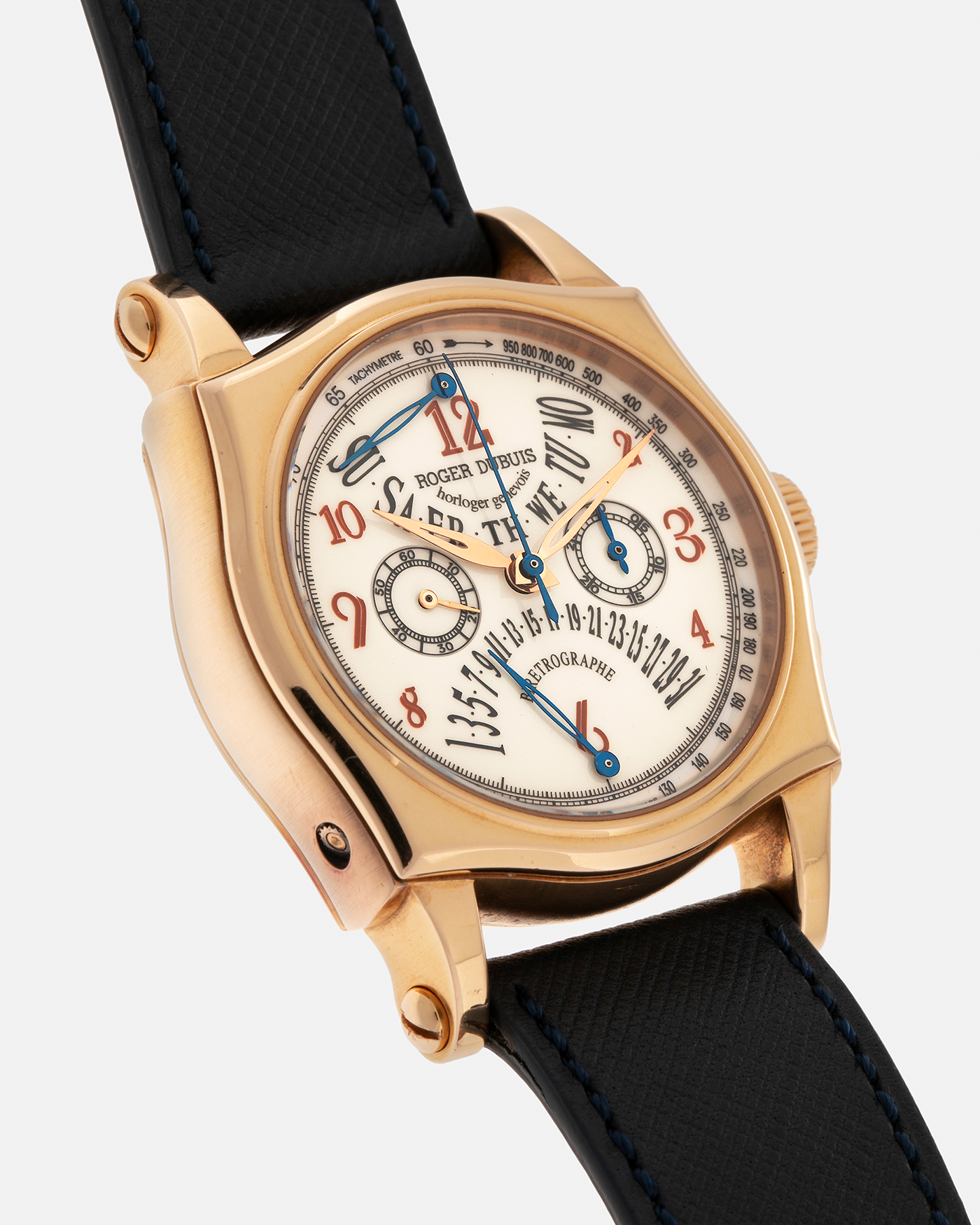 Brand: Roger Dubuis
Year: 2000s
Model: Sympathie 40 Biretrograde Chronograph
Material: 18-carat Yellow Gold
Movement: Roger Dubuis Cal. RD 5630 (Based on the Lemania Cal. 2310), Manual-Winding
Case Dimensions: 40mm x 12.25mm (Lug-to-Lug 47mm)
Lug Width: 22mm
Strap: Molequin Navy Blue Textured Calf Leather Strap with Signed 18-carat Yellow Gold Tang Buckle