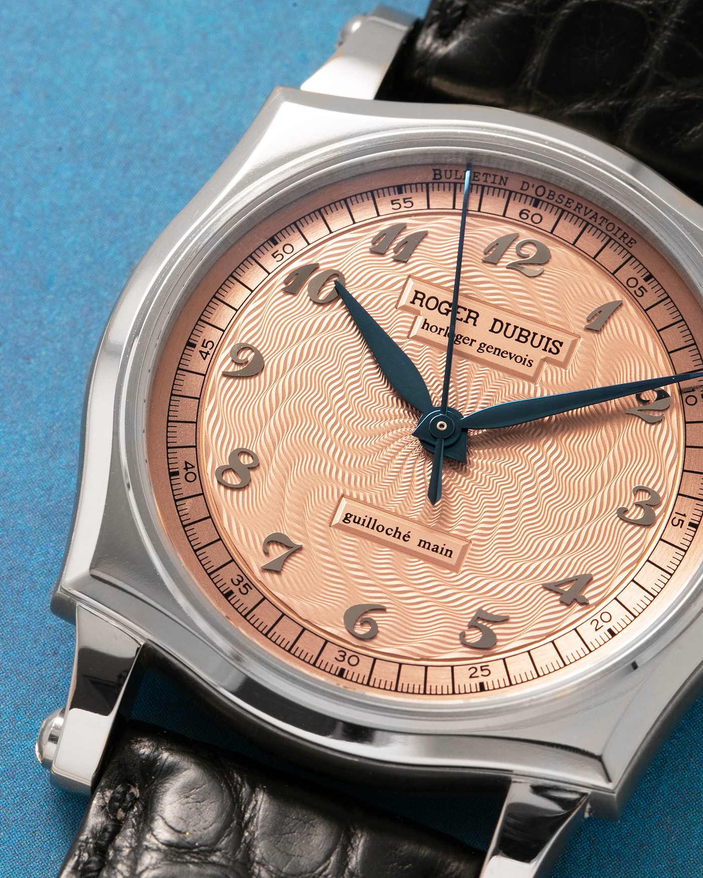 Brand: Roger Dubuis
Year: 2001
Model: Sympathie 37 ‘Salmon Guilloché’, Limited to 28 Pieces
Reference: S37.57.0
Material: 18-carat White Gold
Movement: Roger Dubuis Cal. RD 57, Self-Winding
Case Dimensions: 37mm x 8.5mm (Lug-to-Lug 46.5mm)
Lug Width: 20mm
Strap: Roger Dubuis Black Crocodile Leather Strap with Signed 18-carat White Gold Tang Buckle