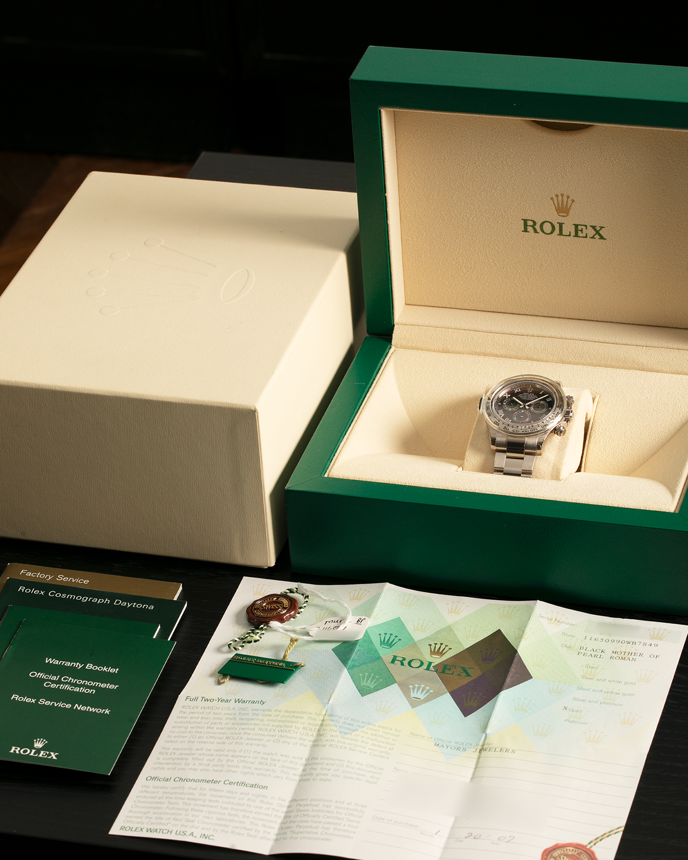 Brand: Rolex
Year: 2007
Model: Cosmograph Daytona
Reference: 116509
Material: 18-carat White Gold Case, Black Tahitian Mother-of-Pearl Dial
Movement: Rolex Cal. 4130, Self-Winding
Case Dimensions: 40mm x 12.4mm (47.6mm Lug-to-Lug)
Lug Width: 20mm
Bracelet: Rolex 78499 Oyster Bracelet in 18-carat White Gold with Signed Oysterlock Clasp