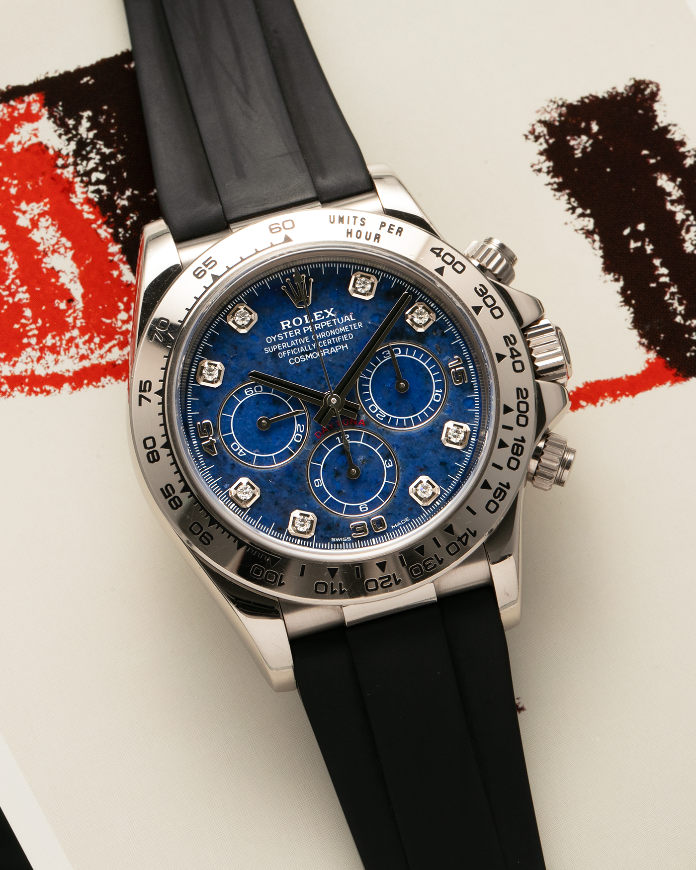Brand: Rolex Year: 1999 Model: Cosmograph Daytona ‘Sodalite’ Reference: 16519 Serial Number: A112XXX Material: 18-carat White Gold Case, Sodalite Stone Dial, Diamond Hour Markers Movement: Rolex Cal. 4030 (Based on the Zenith El Primero Cal. 400), Self-Winding Case Diameter: 40mm Lug Width: 20mm Strap: Black Caoutchouc Rubber Strap with Signed 18-carat White Gold Deployant Clasp, with additional Swiss ABRT Ultramarine Alligator Leather Strap