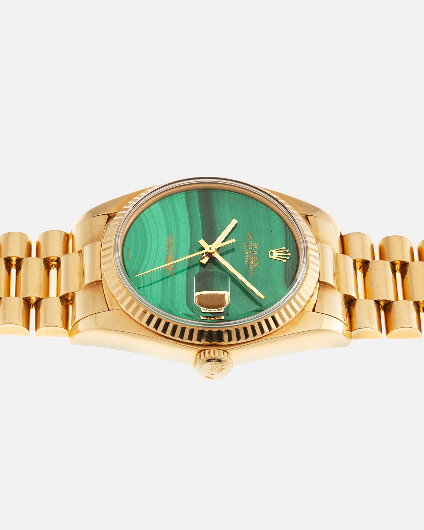 Brand: Rolex Year: 1976 Model: Datejust Reference Number: 1601 Serial Number: 420XXXX Material: 18-carat Yellow Gold, Malachite Stone Dial Movement: Rolex Cal. 1570, Self-Winding Case Diameter: 36mm Lug Width: 20mm Bracelet: Rolex Presidential Bracelet in 18-carat Yellow Gold with Signed Clasp