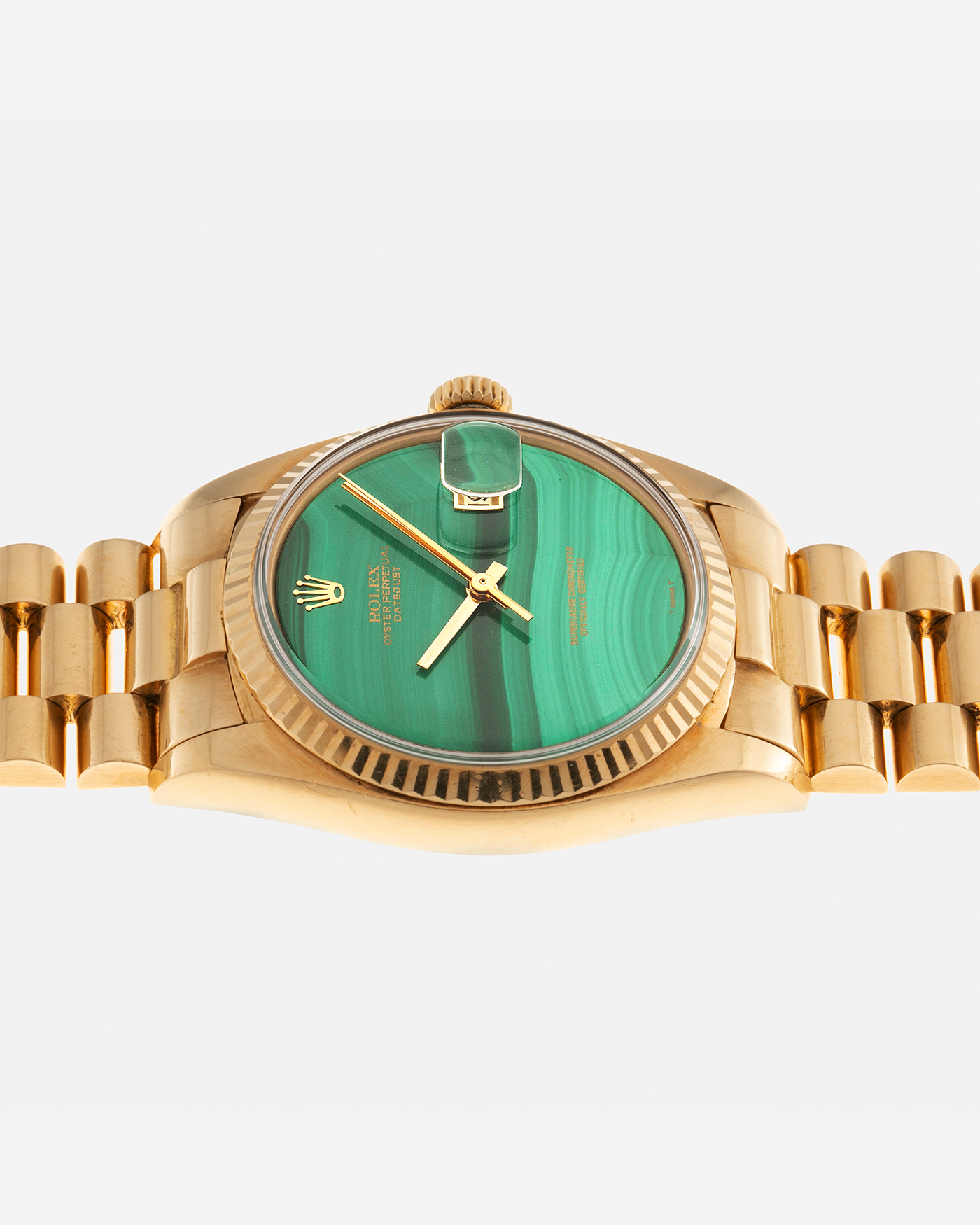 Brand: Rolex Year: 1976 Model: Datejust Reference Number: 1601 Serial Number: 420XXXX Material: 18-carat Yellow Gold, Malachite Stone Dial Movement: Rolex Cal. 1570, Self-Winding Case Diameter: 36mm Lug Width: 20mm Bracelet: Rolex Presidential Bracelet in 18-carat Yellow Gold with Signed Clasp
