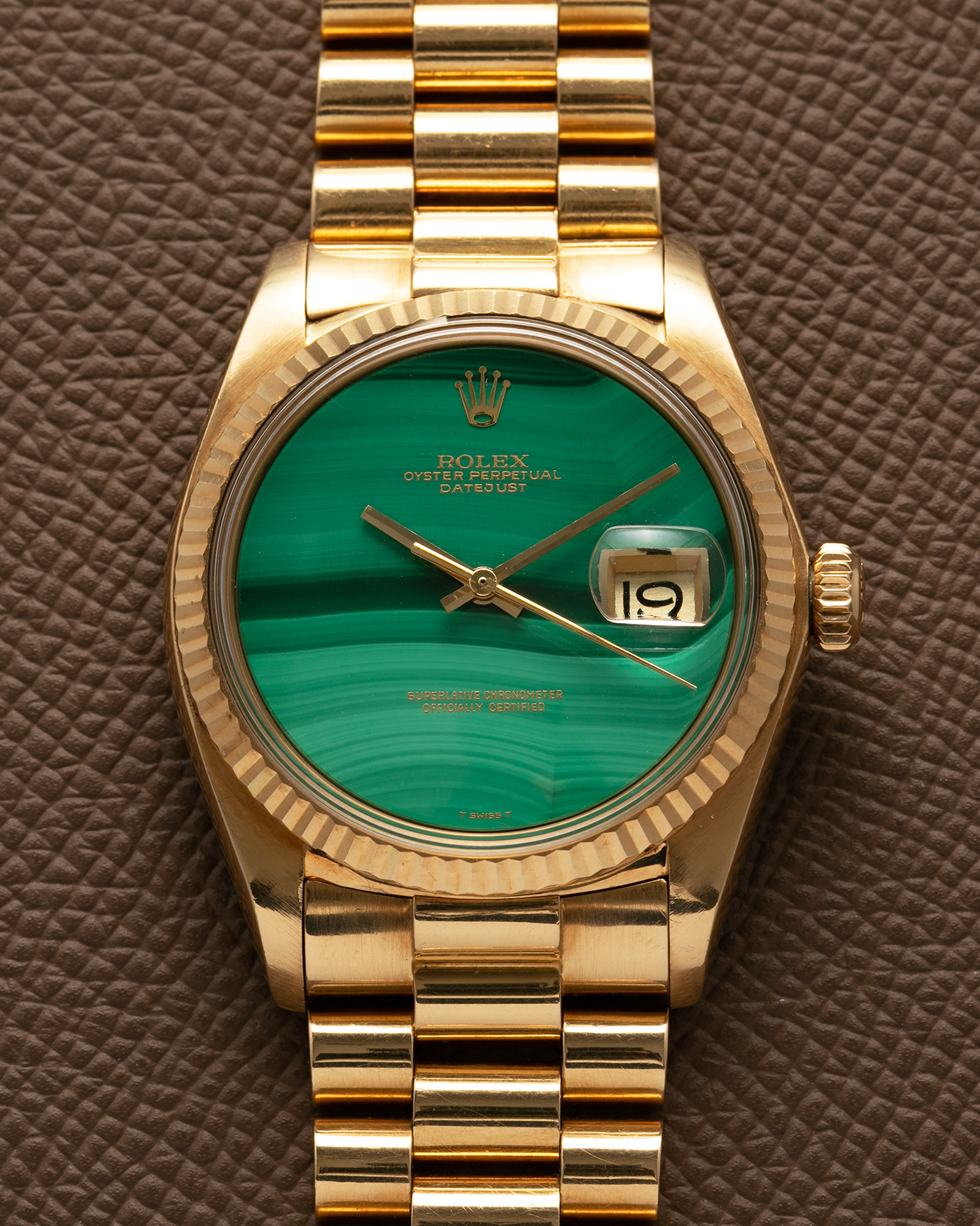 Brand: Rolex Year: 1976 Model: Datejust Reference Number: 1601 Serial Number: 420XXXX Material: 18-carat Yellow Gold, Malachite Stone Dial Movement: Rolex Cal. 1570, Self-Winding Case Diameter: 36mm Lug Width: 20mm Bracelet: Rolex Presidential Bracelet in 18-carat Yellow Gold with Signed Clasp