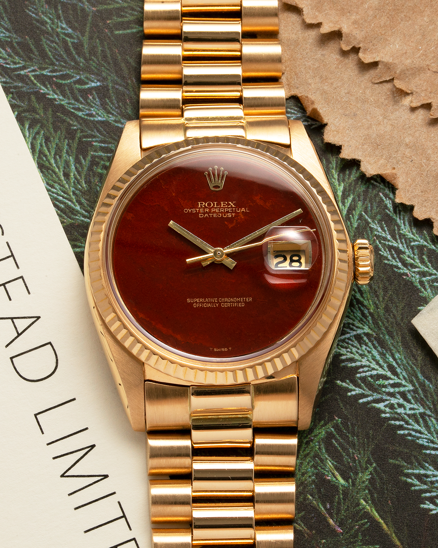 Brand: Rolex Year: 1975 Model: Datejust Reference Number: 1601/8 Serial Number: 392XXXX Material: 18-carat Yellow Gold, Red Jasper Stone Dial Movement: Rolex Cal. 1565, Self-Winding Case Diameter: 36mm Lug Width: 20mm Bracelet: Rolex 18-carat Yellow Gold 8385 Presidential Bracelet with 55B Curved End Links