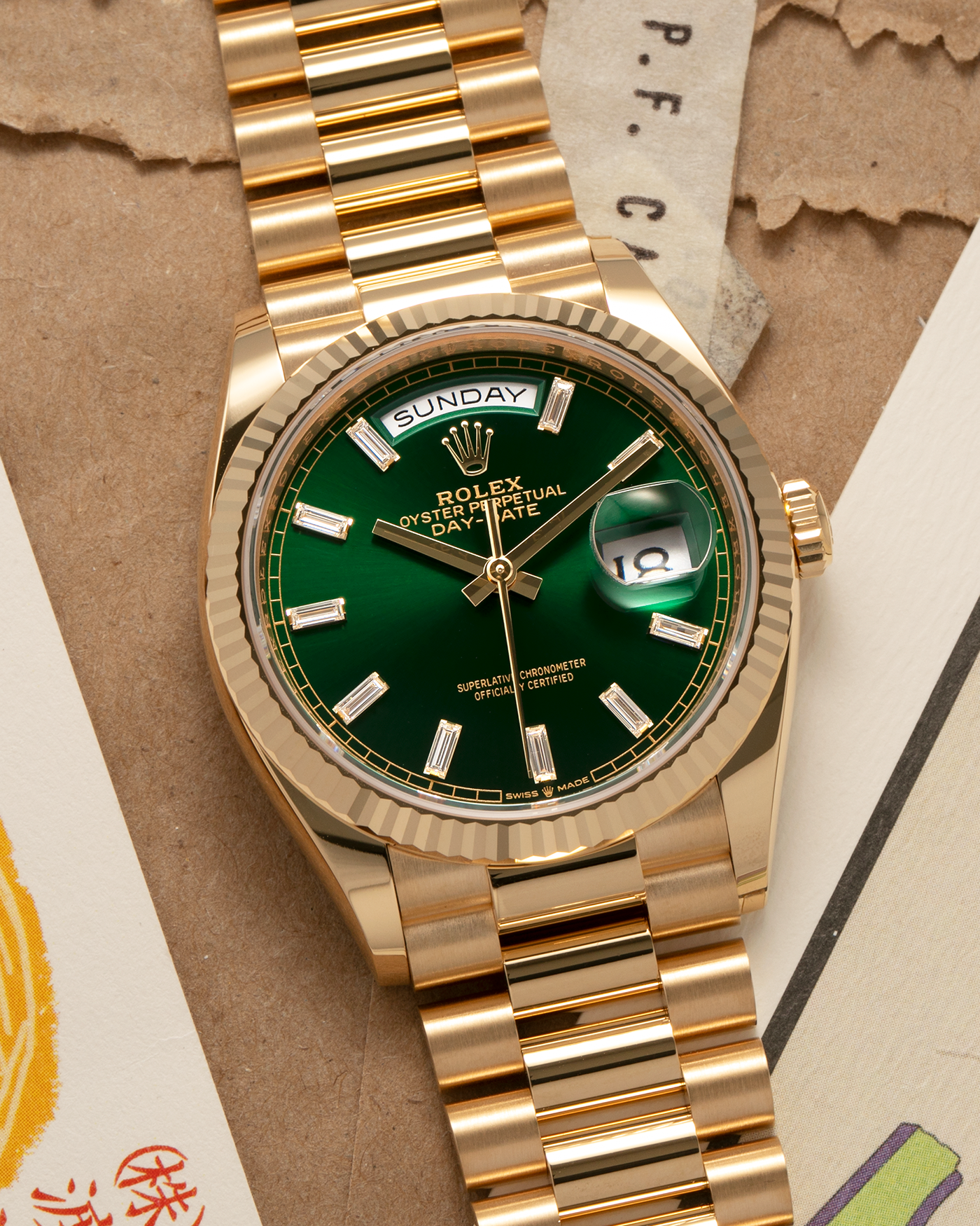 Brand: Rolex
Year: 2024
Model: Day-Date 36 ‘Baguette Diamonds’
Reference Number: 128238
Material: 18-carat Yellow Gold Case, Factory Set Baguette Diamond Hour Markers
Movement: Rolex Cal. 3255, Self-Winding
Case Dimensions: 36mm x 12mm (Lug-to-Lug 43mm)
Lug Width: 20mm
Bracelet: Rolex Presidential Bracelet in 18-carat Yellow Gold with Signed Folding Clasp