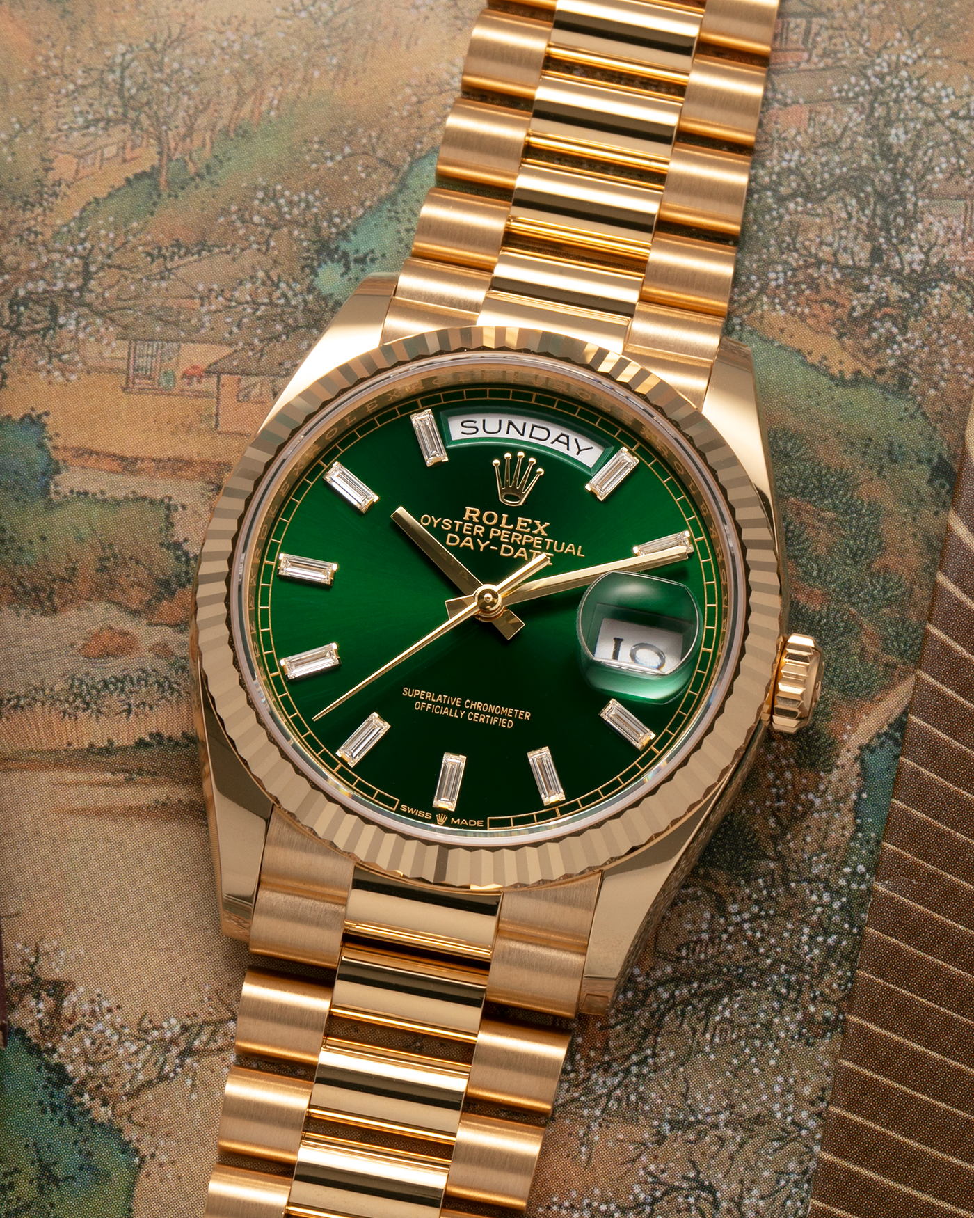 Brand: Rolex
Year: 2024
Model: Day-Date 36 ‘Baguette Diamonds’
Reference Number: 128238
Material: 18-carat Yellow Gold Case, Factory Set Baguette Diamond Hour Markers
Movement: Rolex Cal. 3255, Self-Winding
Case Dimensions: 36mm x 12mm (Lug-to-Lug 43mm)
Lug Width: 20mm
Bracelet: Rolex Presidential Bracelet in 18-carat Yellow Gold with Signed Folding Clasp