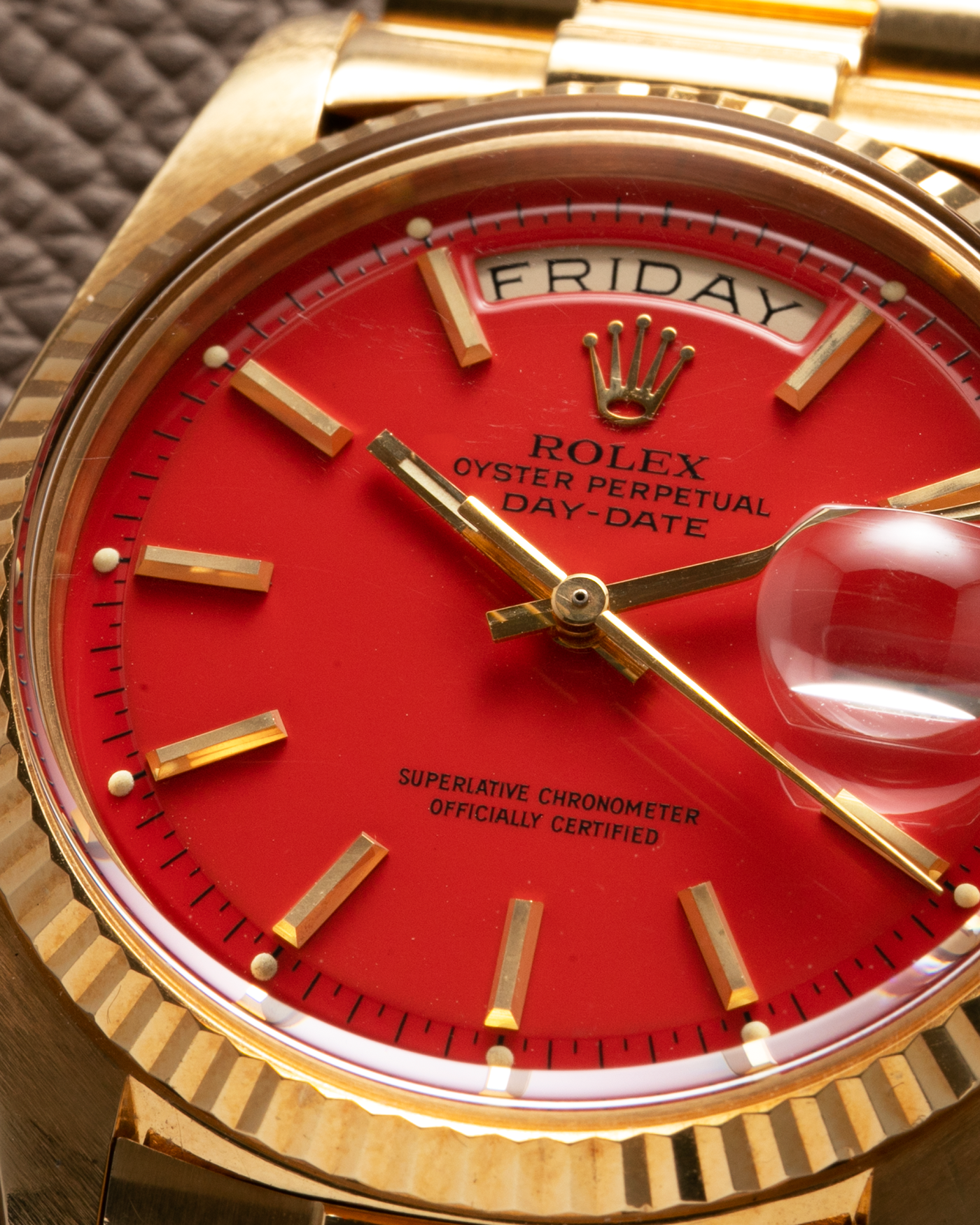 Brand: Rolex Year: 1978 Model: Day-Date, Coral Red ‘Stella’ Reference Number: 1803 Serial: 510XXXX Material: 18-carat Yellow Gold Movement: Rolex Cal. 1556, Self-Winding Case Diameter: 36mm Lug Width: 20mm Bracelet: Rolex 18-carat Yellow Gold ‘F18000’ Stamped Presidential Bracelet with ‘55’ Curved End Links