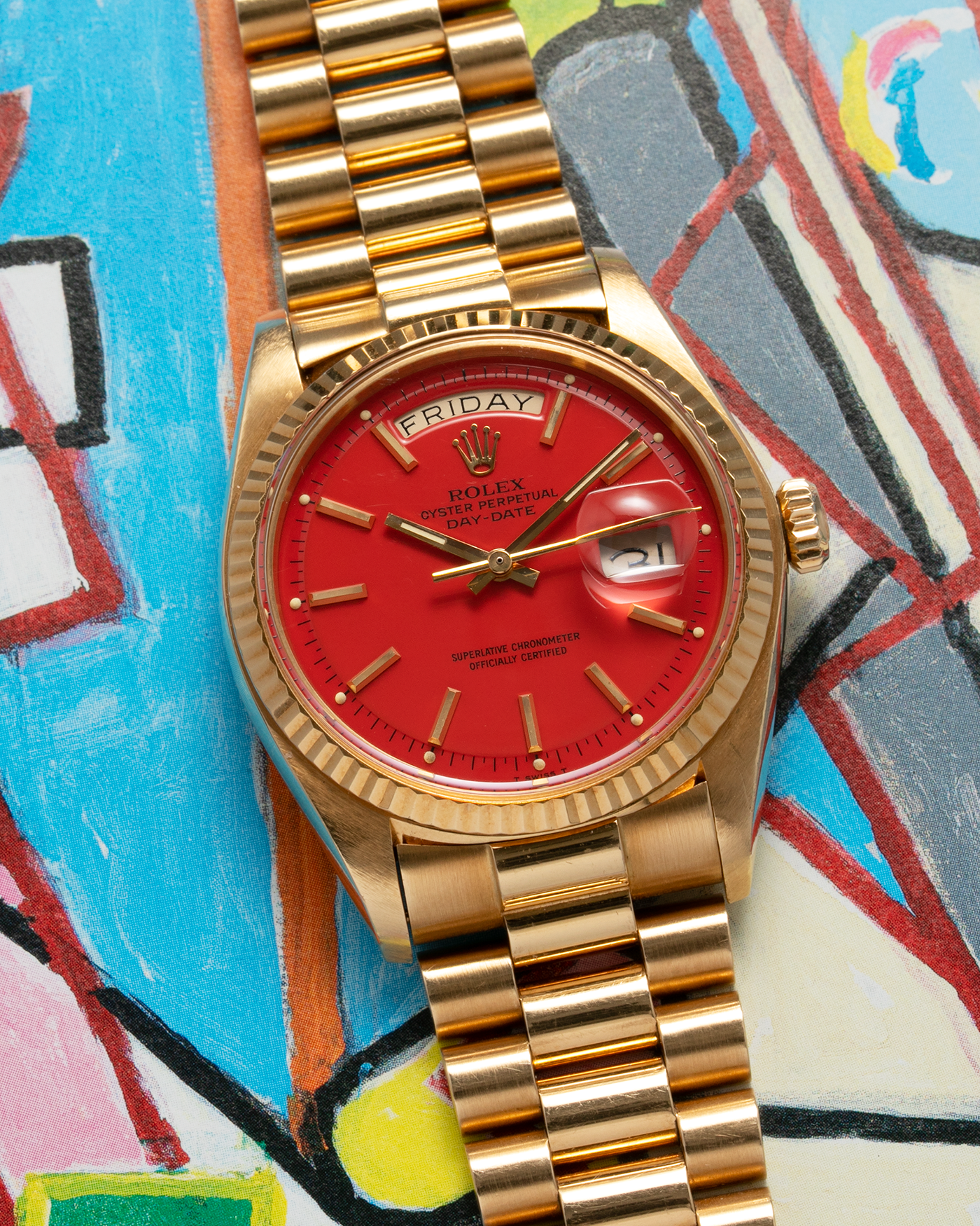 Brand: Rolex Year: 1978 Model: Day-Date, Coral Red ‘Stella’ Reference Number: 1803 Serial: 510XXXX Material: 18-carat Yellow Gold Movement: Rolex Cal. 1556, Self-Winding Case Diameter: 36mm Lug Width: 20mm Bracelet: Rolex 18-carat Yellow Gold ‘F18000’ Stamped Presidential Bracelet with ‘55’ Curved End Links
