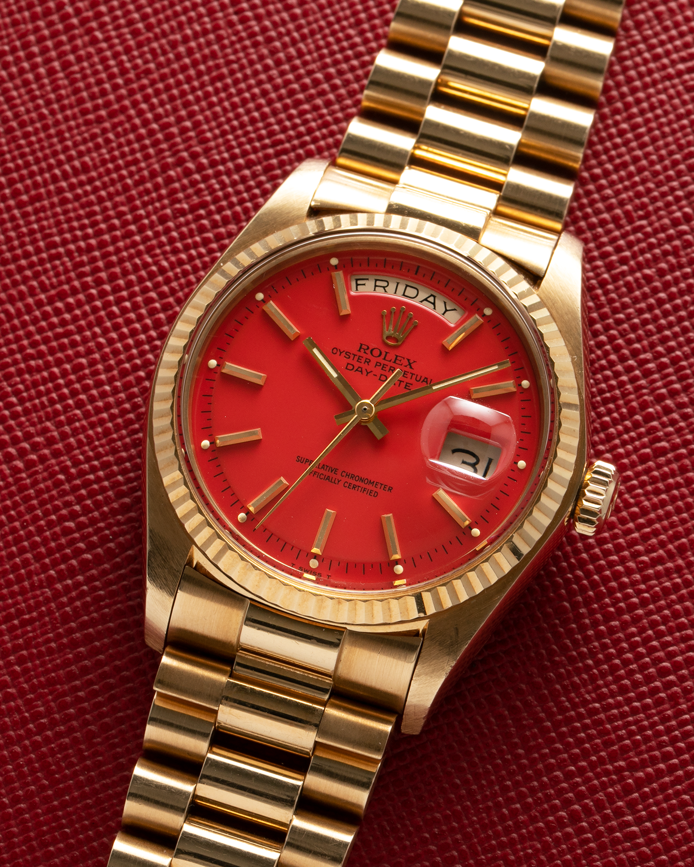 Brand: Rolex Year: 1978 Model: Day-Date, Coral Red ‘Stella’ Reference Number: 1803 Serial: 510XXXX Material: 18-carat Yellow Gold Movement: Rolex Cal. 1556, Self-Winding Case Diameter: 36mm Lug Width: 20mm Bracelet: Rolex 18-carat Yellow Gold ‘F18000’ Stamped Presidential Bracelet with ‘55’ Curved End Links