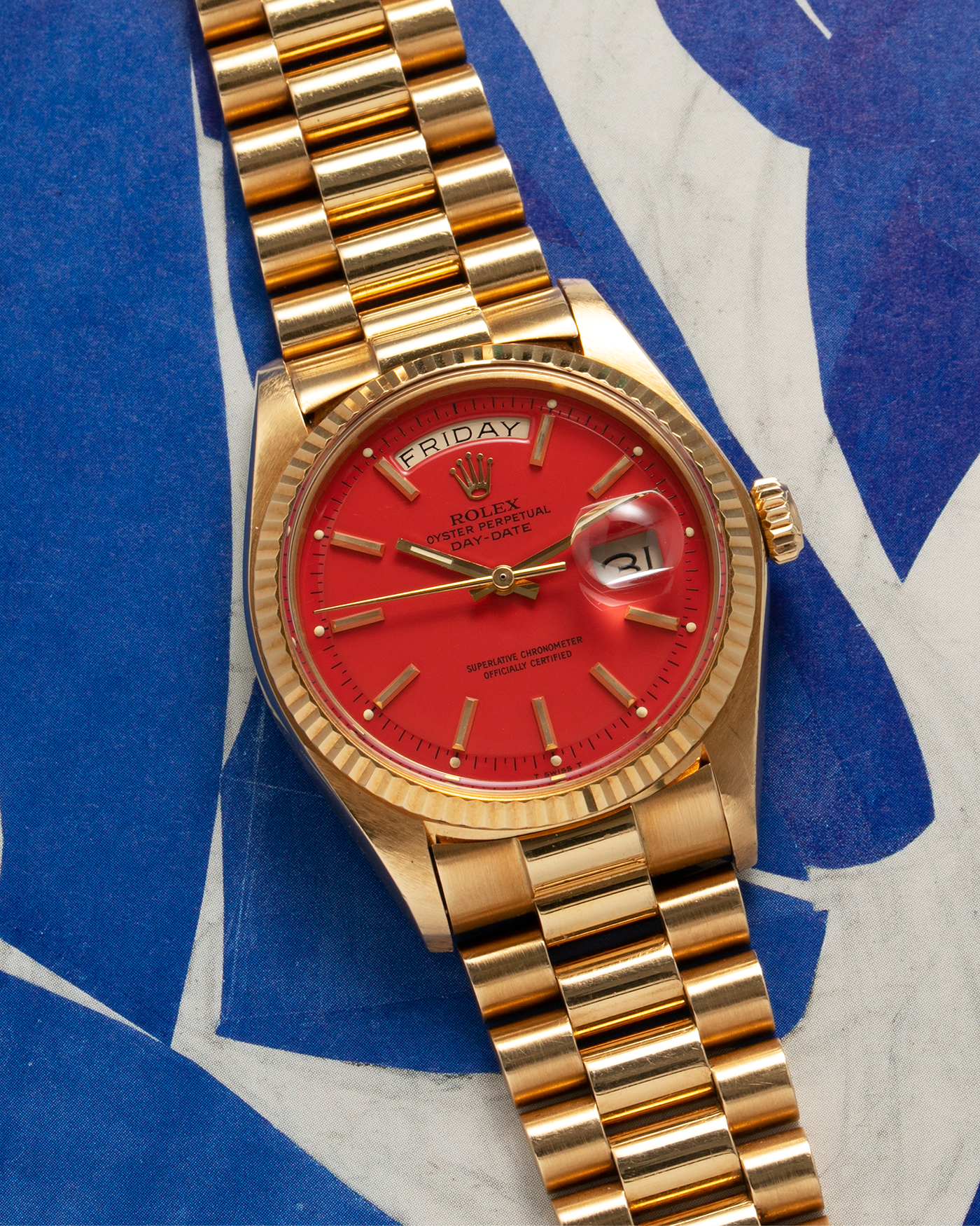 Brand: Rolex Year: 1978 Model: Day-Date, Coral Red ‘Stella’ Reference Number: 1803 Serial: 510XXXX Material: 18-carat Yellow Gold Movement: Rolex Cal. 1556, Self-Winding Case Diameter: 36mm Lug Width: 20mm Bracelet: Rolex 18-carat Yellow Gold ‘F18000’ Stamped Presidential Bracelet with ‘55’ Curved End Links