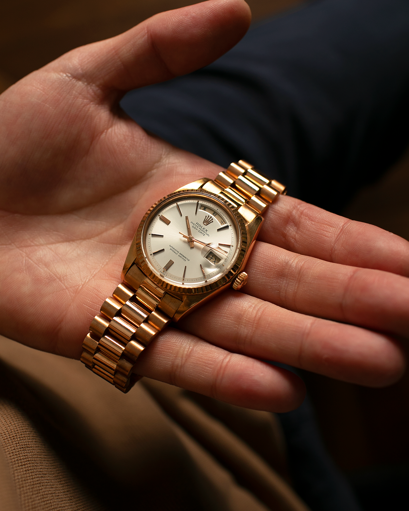 Brand: Rolex
Year: 1968
Model: Day-Date, ‘Doorstop’ Dial
Reference Number: 1803
Serial: 178XXXX
Material: 18-carat Rose Gold
Movement: Rolex Cal. 1556, Self-Winding
Case Dimensions: 36mm x 12.5mm (Lug-to-Lug 43mm)
Lug Width: 20mm
Bracelet: Rolex Presidential Bracelet in 18-carat Rose Gold with Signed Folding Clasp