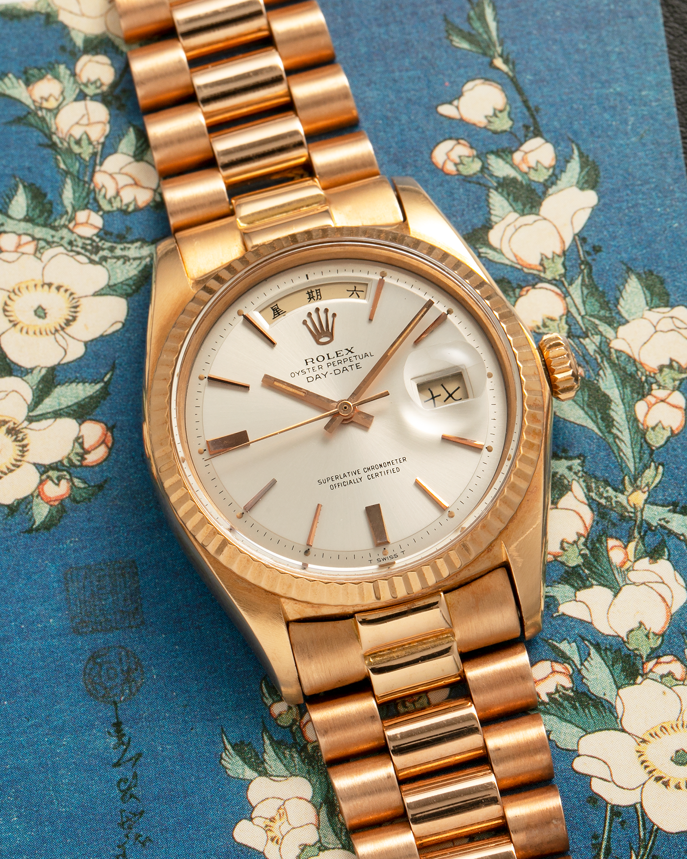Brand: Rolex
Year: 1968
Model: Day-Date, ‘Doorstop’ Dial
Reference Number: 1803
Serial: 178XXXX
Material: 18-carat Rose Gold
Movement: Rolex Cal. 1556, Self-Winding
Case Dimensions: 36mm x 12.5mm (Lug-to-Lug 43mm)
Lug Width: 20mm
Bracelet: Rolex Presidential Bracelet in 18-carat Rose Gold with Signed Folding Clasp