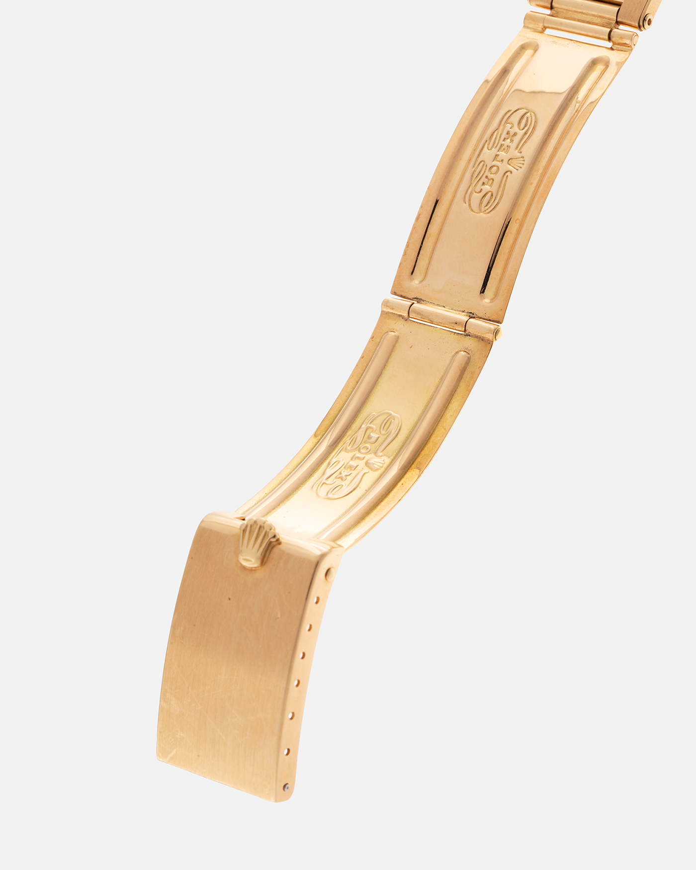 Brand: Rolex
Year: 1971
Model: Day-Date ‘Wide Boy'
Reference Number: 1803
Serial Number: 285XXXX
Material: 18-carat Yellow Gold
Movement: Rolex Cal. 1556, Self-Winding
Case Dimensions: 36mm x 12.5mm (Lug-to-Lug 43mm)
Lug Width: 20mm
Bracelet: Rolex Gay Frères Oyster Rivet Bracelet in 18-carat Yellow Gold with ‘76’ Endlinks and Signed Clasp
