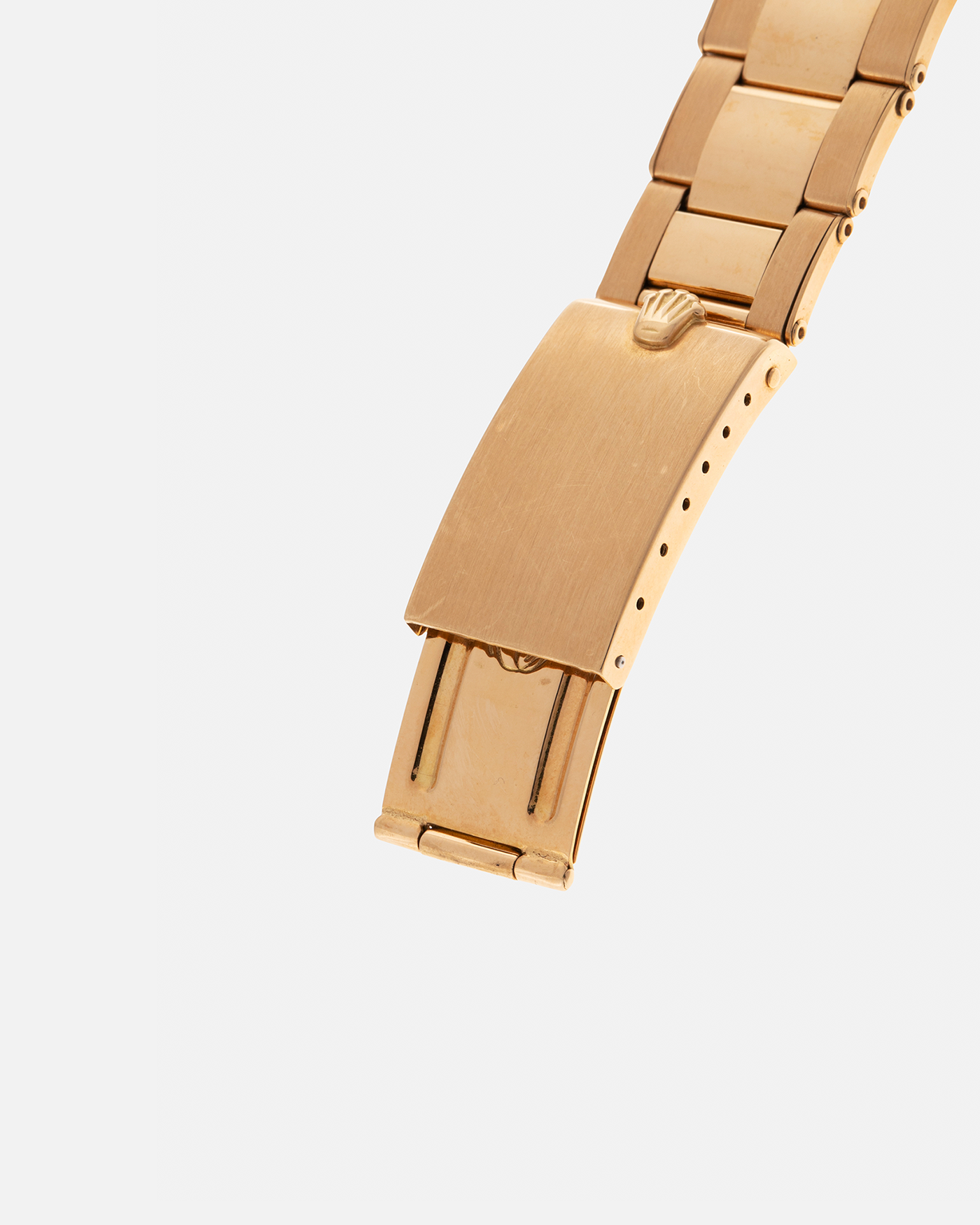 Brand: Rolex
Year: 1971
Model: Day-Date ‘Wide Boy'
Reference Number: 1803
Serial Number: 285XXXX
Material: 18-carat Yellow Gold
Movement: Rolex Cal. 1556, Self-Winding
Case Dimensions: 36mm x 12.5mm (Lug-to-Lug 43mm)
Lug Width: 20mm
Bracelet: Rolex Gay Frères Oyster Rivet Bracelet in 18-carat Yellow Gold with ‘76’ Endlinks and Signed Clasp