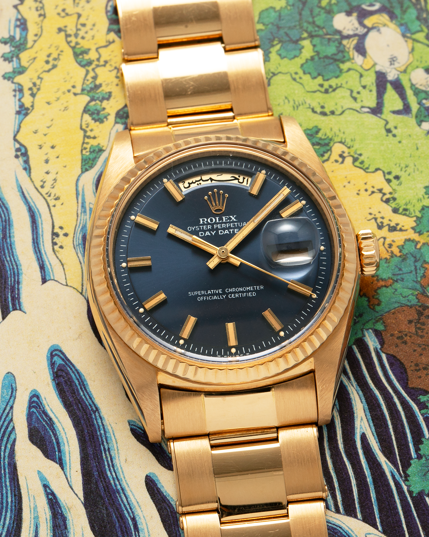 Brand: Rolex
Year: 1971
Model: Day-Date ‘Wide Boy'
Reference Number: 1803
Serial Number: 285XXXX
Material: 18-carat Yellow Gold
Movement: Rolex Cal. 1556, Self-Winding
Case Dimensions: 36mm x 12.5mm (Lug-to-Lug 43mm)
Lug Width: 20mm
Bracelet: Rolex Gay Frères Oyster Rivet Bracelet in 18-carat Yellow Gold with ‘76’ Endlinks and Signed Clasp