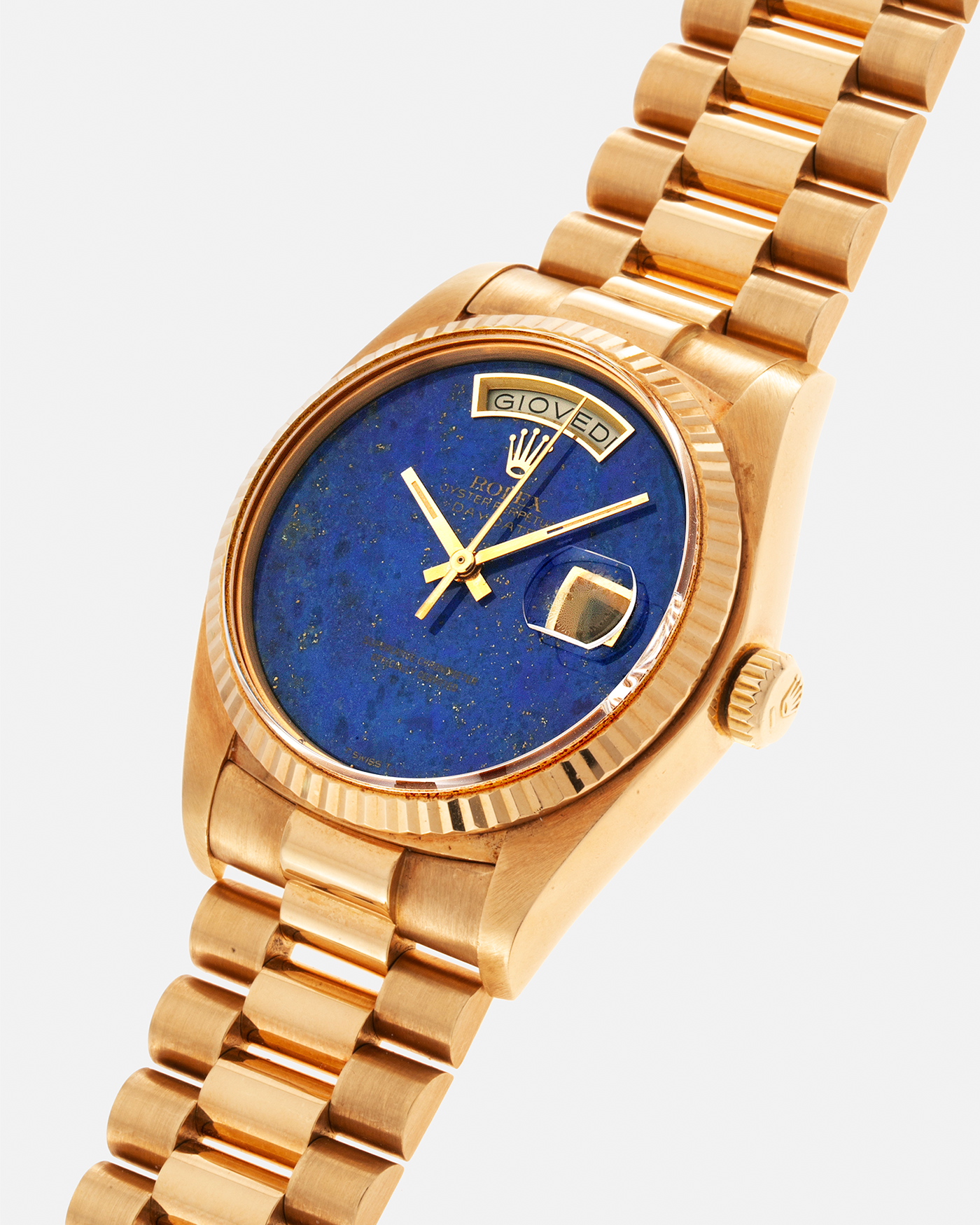 Brand: Rolex Year: 1979 Model: Day-Date, ‘Lapis Lazuli’ Reference Number: 18038 Serial: 612XXXX Material: 18-carat Yellow Gold Movement: Rolex Cal. 3055, Self-Winding Case Diameter: 36mm Lug Width: 20mm Bracelet: Rolex ‘8385’ 18-carat Solid Gold Presidential Bracelet with ‘55’ Curved End Links