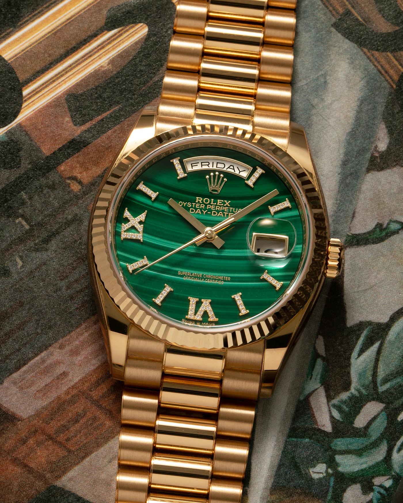 Brand: Rolex Year: 2021 Model: Day-Date 36 ‘Malachite Diamond’ Reference Number: 128238 Serial Number: 6H47XXXX Material: 18-carat Yellow Gold Case, Green Malachite Dial, Factory Set Diamond Roman-Style Hour Markers Movement: Rolex Cal. 3255, Self-Winding Case Diameter: 36mm Bracelet: Rolex Presidential Bracelet in 18-carat Yellow Gold