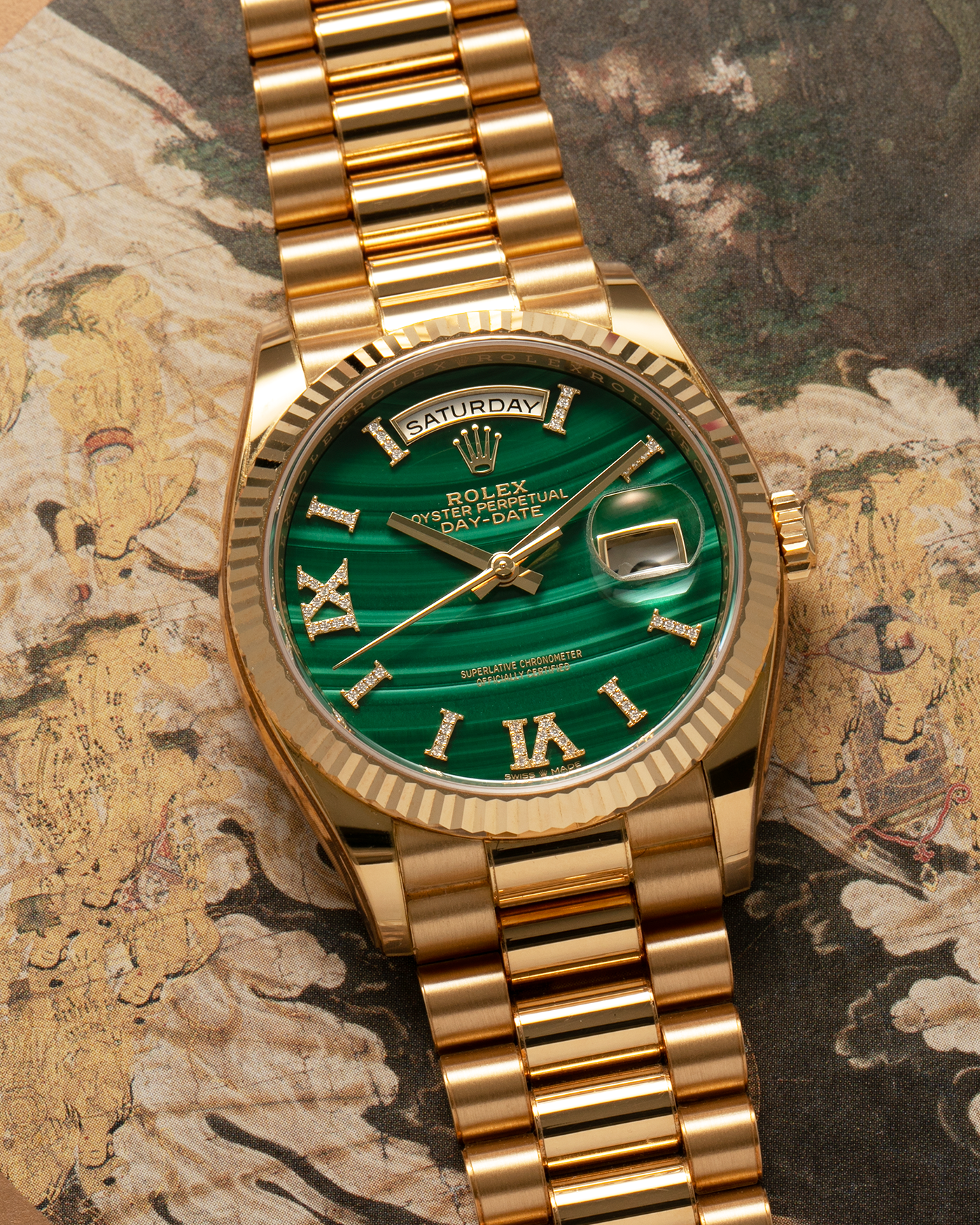 Brand: Rolex Year: 2021 Model: Day-Date 36 ‘Malachite Diamond’ Reference Number: 128238 Serial Number: 6H47XXXX Material: 18-carat Yellow Gold Case, Green Malachite Dial, Factory Set Diamond Roman-Style Hour Markers Movement: Rolex Cal. 3255, Self-Winding Case Diameter: 36mm Bracelet: Rolex Presidential Bracelet in 18-carat Yellow Gold