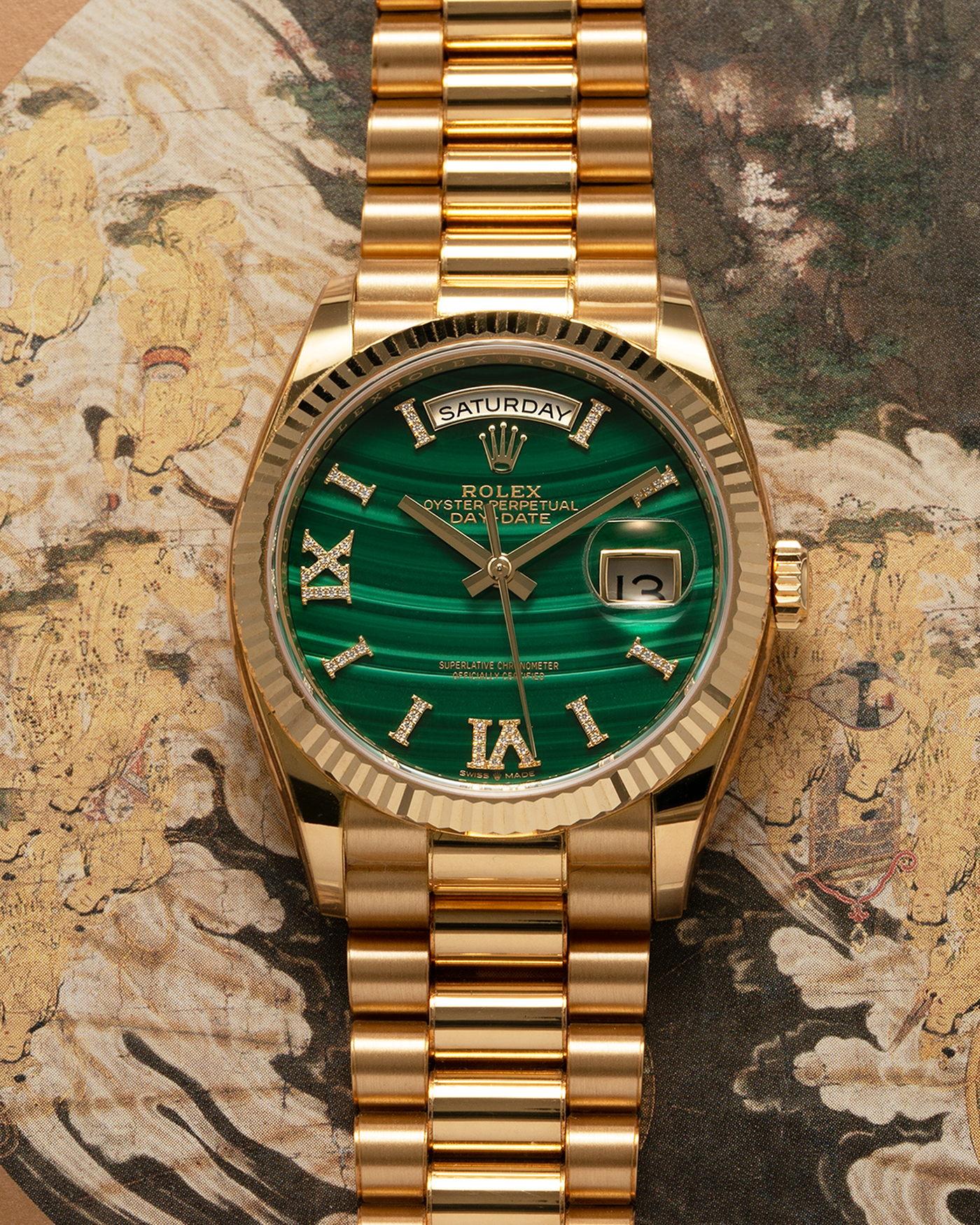 Brand: Rolex Year: 2021 Model: Day-Date 36 ‘Malachite Diamond’ Reference Number: 128238 Serial Number: 6H47XXXX Material: 18-carat Yellow Gold Case, Green Malachite Dial, Factory Set Diamond Roman-Style Hour Markers Movement: Rolex Cal. 3255, Self-Winding Case Diameter: 36mm Bracelet: Rolex Presidential Bracelet in 18-carat Yellow Gold