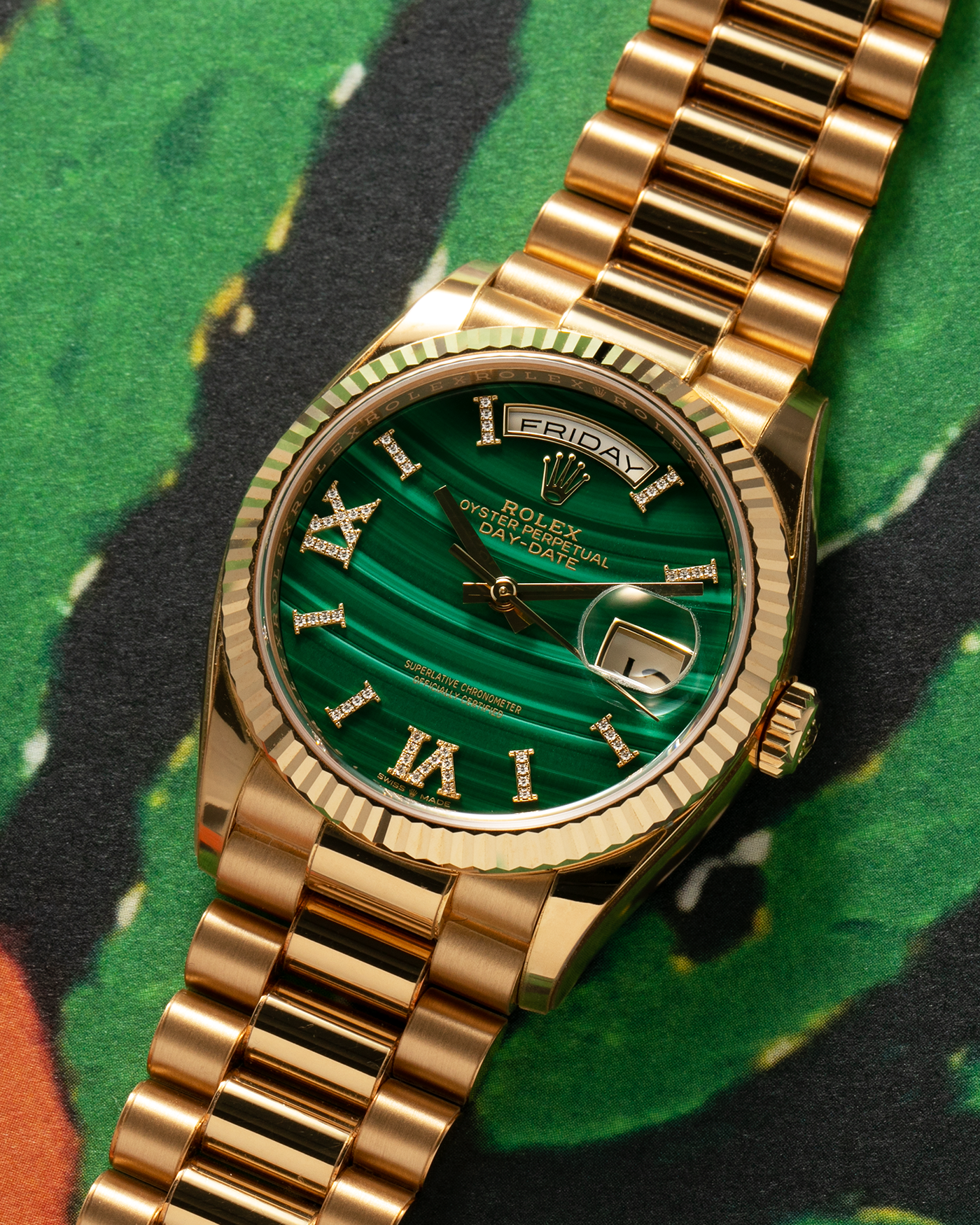 Brand: Rolex Year: 2021 Model: Day-Date 36 ‘Malachite Diamond’ Reference Number: 128238 Serial Number: 6H47XXXX Material: 18-carat Yellow Gold Case, Green Malachite Dial, Factory Set Diamond Roman-Style Hour Markers Movement: Rolex Cal. 3255, Self-Winding Case Diameter: 36mm Bracelet: Rolex Presidential Bracelet in 18-carat Yellow Gold