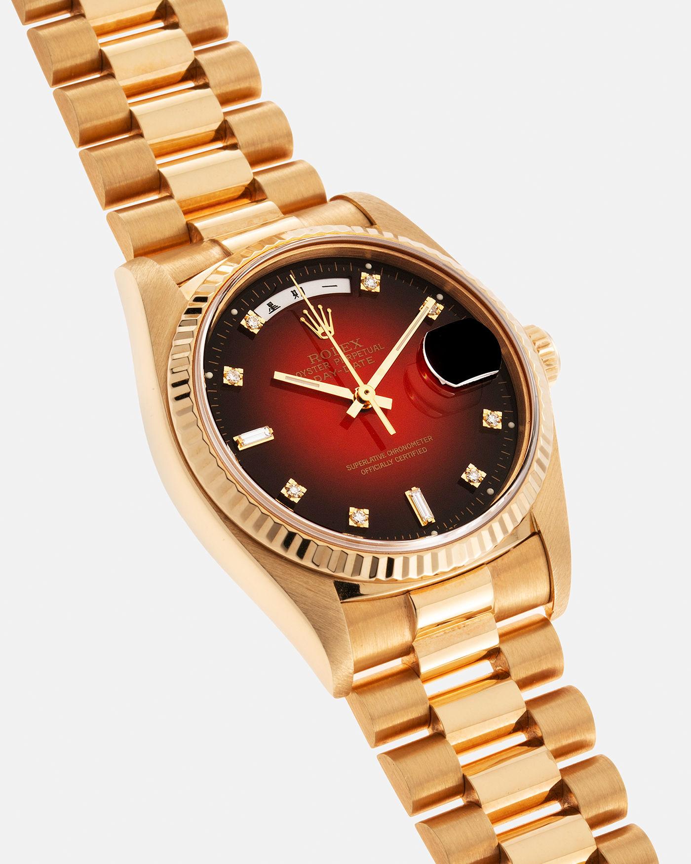 Brand: Rolex Year: 1979 Serial Number: 626XXXX Model: Day Date, Red Vignette Lacquer Dial, Chinese Day and Date Discs Reference Number: 18038 Material: 18-carat Yellow Gold Movement: Cal. 3055, Self-Winding Case Diameter: 36mm Lug Width: 20mm Bracelet: Rolex 8385 18-carat Yellow Gold Presidential Bracelet