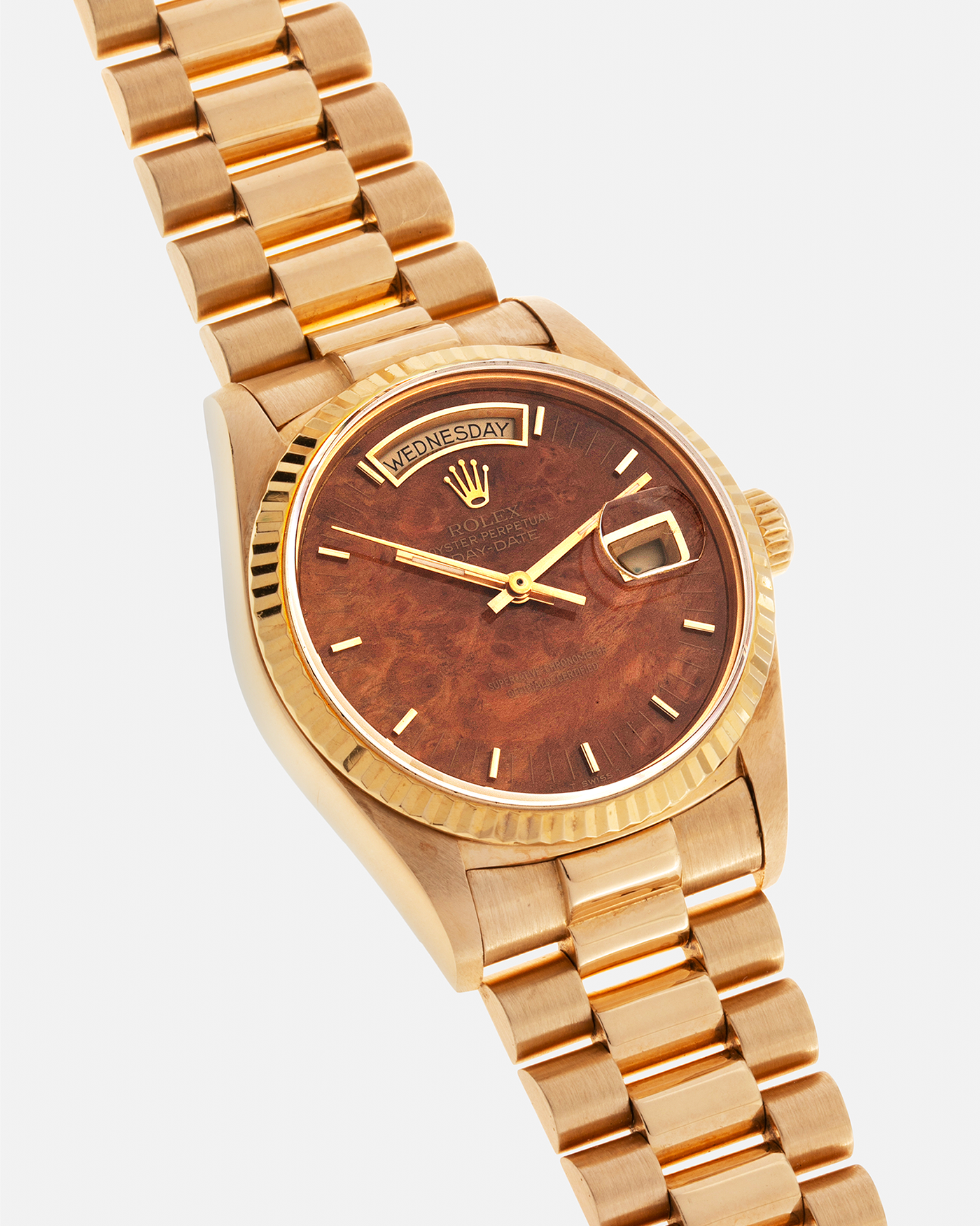 Brand: Rolex Year: 1988 Model: Day Date Reference Number: 18038 Serial Number: R586XXX Material: 18-carat Yellow Gold, ‘Burl Wood’ Dial Movement: Rolex Cal. 3055, Self-Winding Case Diameter: 36mm Lug Width: 20mm Bracelet: Rolex 18-carat Yellow Gold 8385 Presidential Bracelet with 55 Curved End Links