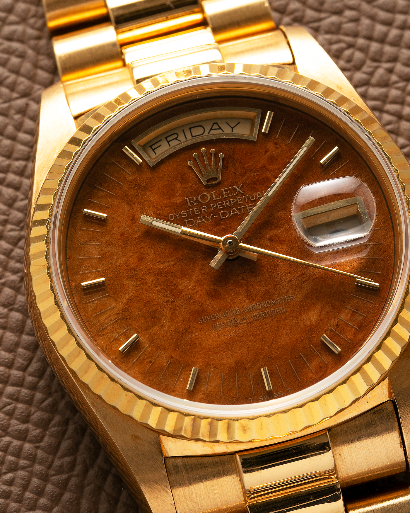 Brand: Rolex Year: 1988 Model: Day Date Reference Number: 18038 Serial Number: R586XXX Material: 18-carat Yellow Gold, ‘Burl Wood’ Dial Movement: Rolex Cal. 3055, Self-Winding Case Diameter: 36mm Lug Width: 20mm Bracelet: Rolex 18-carat Yellow Gold 8385 Presidential Bracelet with 55 Curved End Links