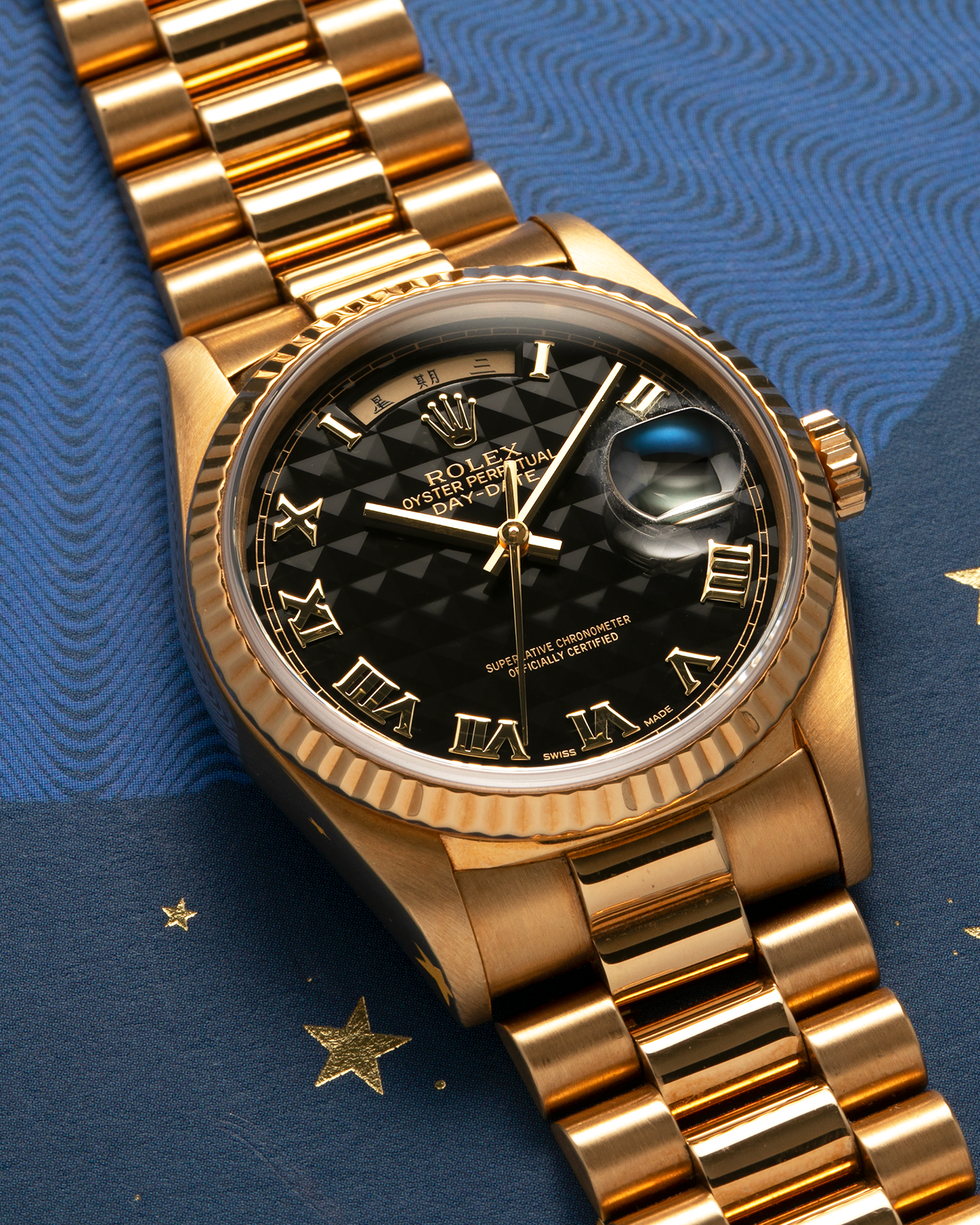 Brand: Rolex
Year: 1989
Model: Day-Date ‘Black Pyramid’
Reference Number: 18238
Serial Number: L551XXX
Material: 18-carat Yellow Gold
Movement: Rolex Cal. 3155, Self-Winding
Case Diameter: 36mm (Lug-to-Lug 43.7mm)
Lug Width: 20mm
Bracelet: Rolex 18-carat Yellow Gold ‘8385’ Presidential Bracelet with 55B Curved End Links and Signed ‘N8’ Folding Clasp