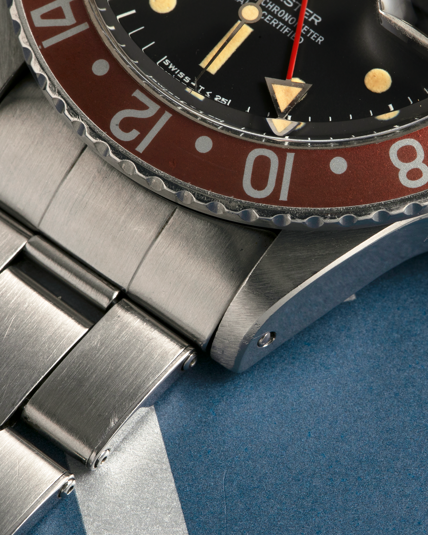 Brand: Rolex
Year: 1976
Model: GMT-Master
Reference Number: 1675
Serial Number: 420XXXX
Material: Stainless Steel
Movement: Rolex Cal. 1575, Self-Winding
Case Dimensions: 40mm x 13mm (Lug-to-Lug 47.5mm)
Lug Width: 20mm
Bracelet: Rolex Stainless Steel Folded Oyster Bracelet with Signed ‘76’ Marked Deployant Clasp