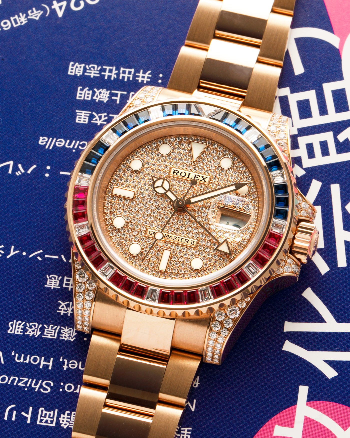 Brand: Rolex
Year: 2020
Model: GMT Master II
Reference Number: 126755SARU
Material: 18-carat Everose, Rubies And Sapphire Bezel, Diamond Pavé Lugs and Crown Guards, Diamond Pavé Dial
Movement: Rolex Cal. 3285, Self-Winding
Case Dimensions: 40mm Diameter 12.3mm Thickness
Lug Width: 20mm
Bracelet: Rolex Oyster Bracelet in 18-carat Everose with Signed Oysterlock Folding Clasp
