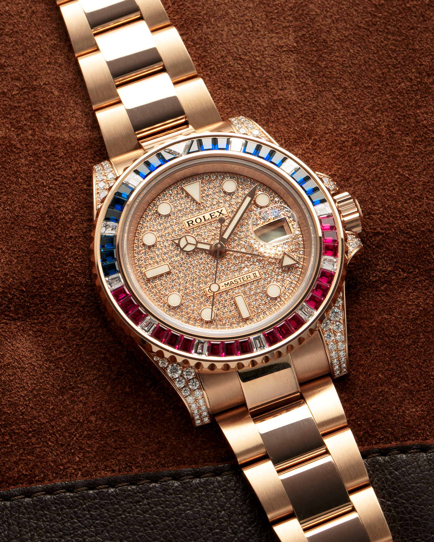 Brand: Rolex
Year: 2020
Model: GMT Master II
Reference Number: 126755SARU
Material: 18-carat Everose, Rubies And Sapphire Bezel, Diamond Pavé Lugs and Crown Guards, Diamond Pavé Dial
Movement: Rolex Cal. 3285, Self-Winding
Case Dimensions: 40mm Diameter 12.3mm Thickness
Lug Width: 20mm
Bracelet: Rolex Oyster Bracelet in 18-carat Everose with Signed Oysterlock Folding Clasp
