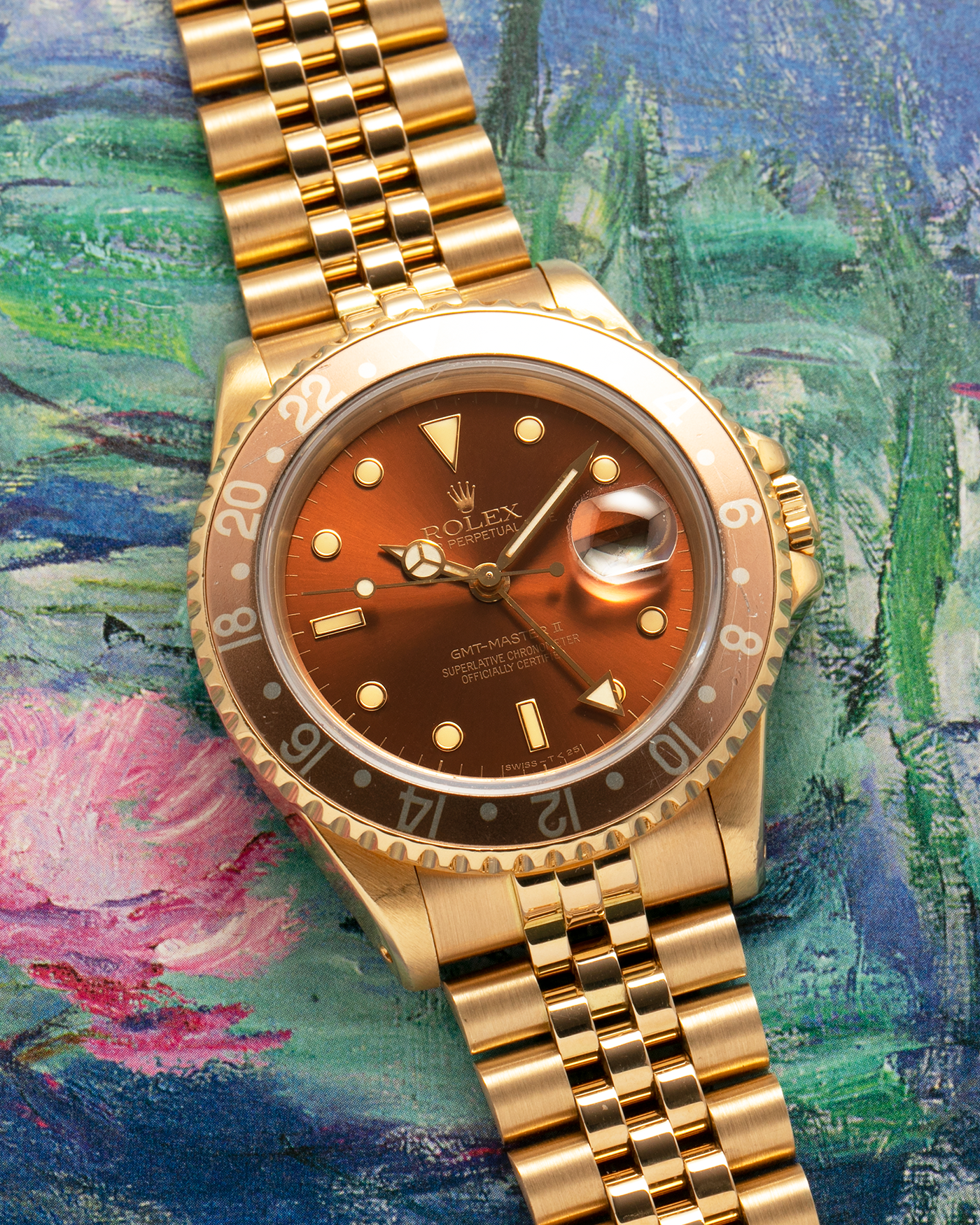 Brand: Rolex
Year: 1994
Model: GMT Master II
Reference Number: 16718
Serial Number: N281XXX
Material: 18-carat Yellow Gold
Movement: Rolex Cal. 3185, Self-Winding
Case Dimensions: 40mm x 12mm (Lug-to-Lug 42.5mm)
Lug Width: 20mm
Bracelet: Rolex 18-carat Yellow Gold 8386 Jubilee Bracelet with 47B Curved End Links
