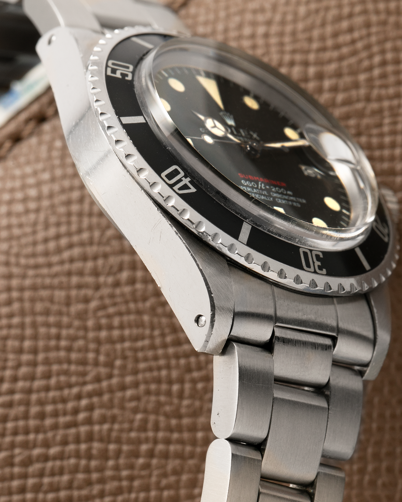 Brand: Rolex
Year: 1976
Model: Submariner
Reference Number: 1680 ‘Red’
Serial Number: 38XXXXX
Material: Stainless Steel
Movement: Rolex Cal. 1575, Self-Winding
Case Dimensions: 40mm
Lug Width: 20mm
Bracelet: Rolex 93150 Oyster Bracelet with Signed Stainless Steel Clasp and XXX End Links