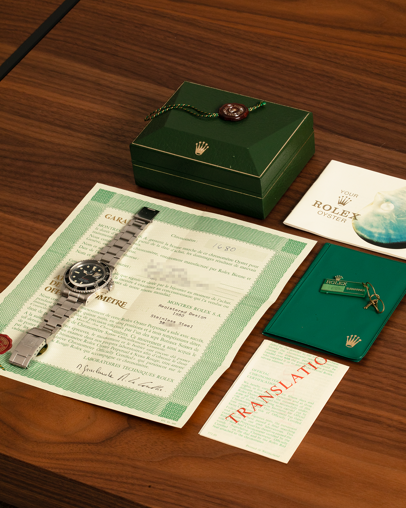 Brand: Rolex
Year: 1976
Model: Submariner
Reference Number: 1680 ‘Red’
Serial Number: 38XXXXX
Material: Stainless Steel
Movement: Rolex Cal. 1575, Self-Winding
Case Dimensions: 40mm
Lug Width: 20mm
Bracelet: Rolex 93150 Oyster Bracelet with Signed Stainless Steel Clasp and XXX End Links