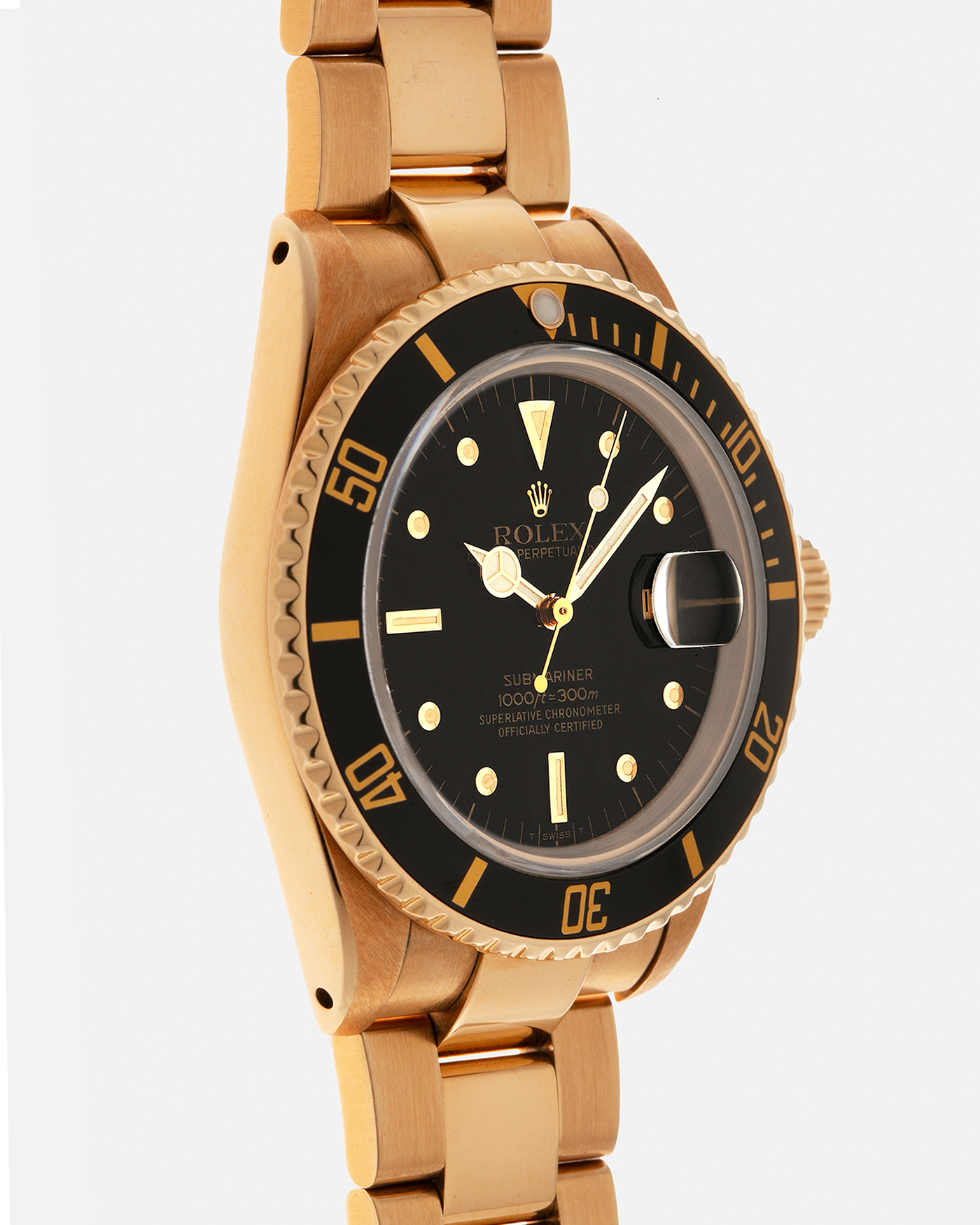 Brand: Rolex
Year: 1984
Model: Submariner
Reference Number: 16808
Serial Number: 838XXXX
Material: 18-carat Yellow Gold
Movement: Rolex Cal. 3035, Self-Winding
Case Dimensions: 40mm x 12.5mm (Lug-to-Lug 47.5mm)
Lug Width: 20mm
Bracelet: Rolex 92908 Oyster Bracelet in 18-carat Yellow Gold With Signed Deployant Clasp with Dive Extension