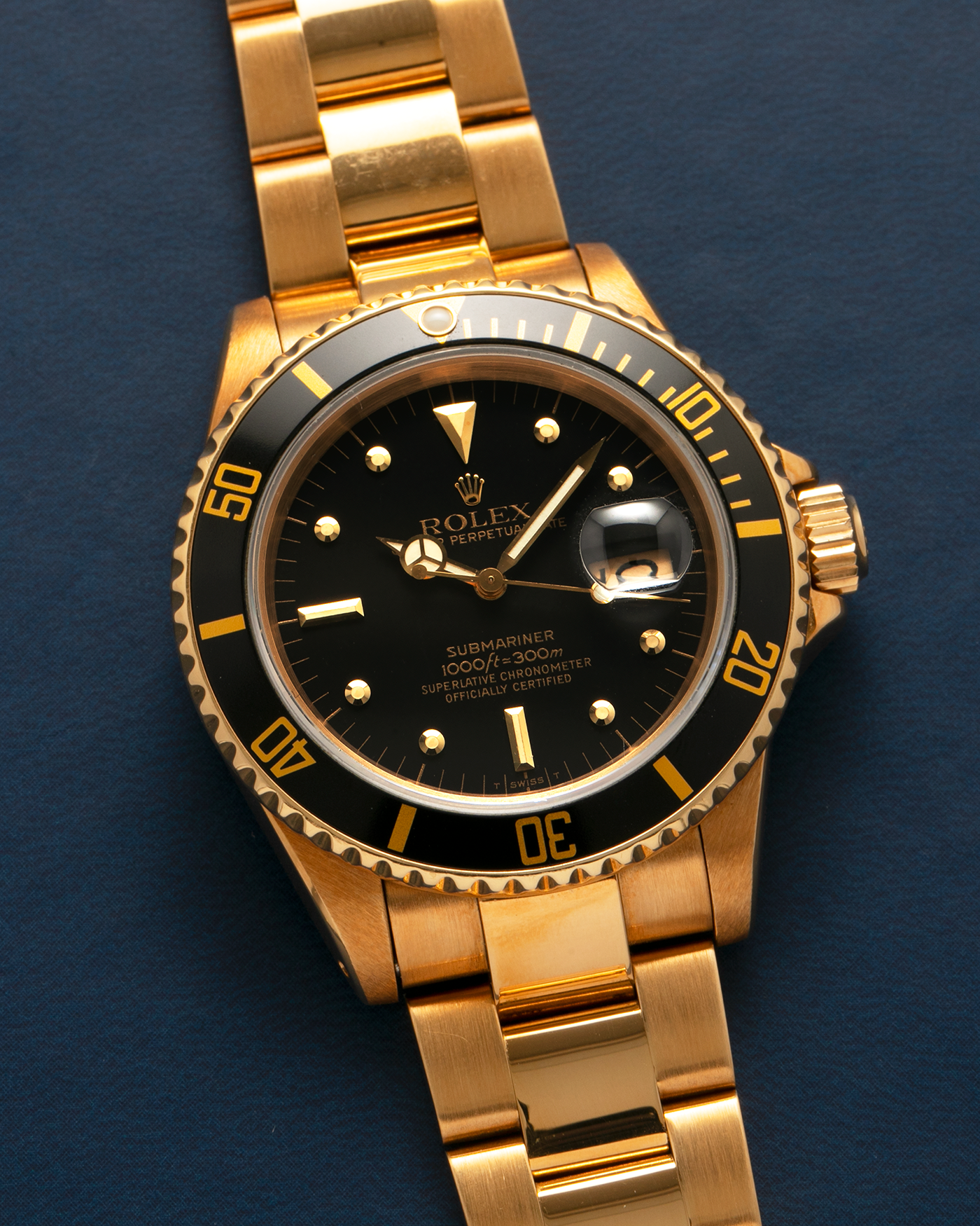 Brand: Rolex
Year: 1984
Model: Submariner
Reference Number: 16808
Serial Number: 838XXXX
Material: 18-carat Yellow Gold
Movement: Rolex Cal. 3035, Self-Winding
Case Dimensions: 40mm x 12.5mm (Lug-to-Lug 47.5mm)
Lug Width: 20mm
Bracelet: Rolex 92908 Oyster Bracelet in 18-carat Yellow Gold With Signed Deployant Clasp with Dive Extension