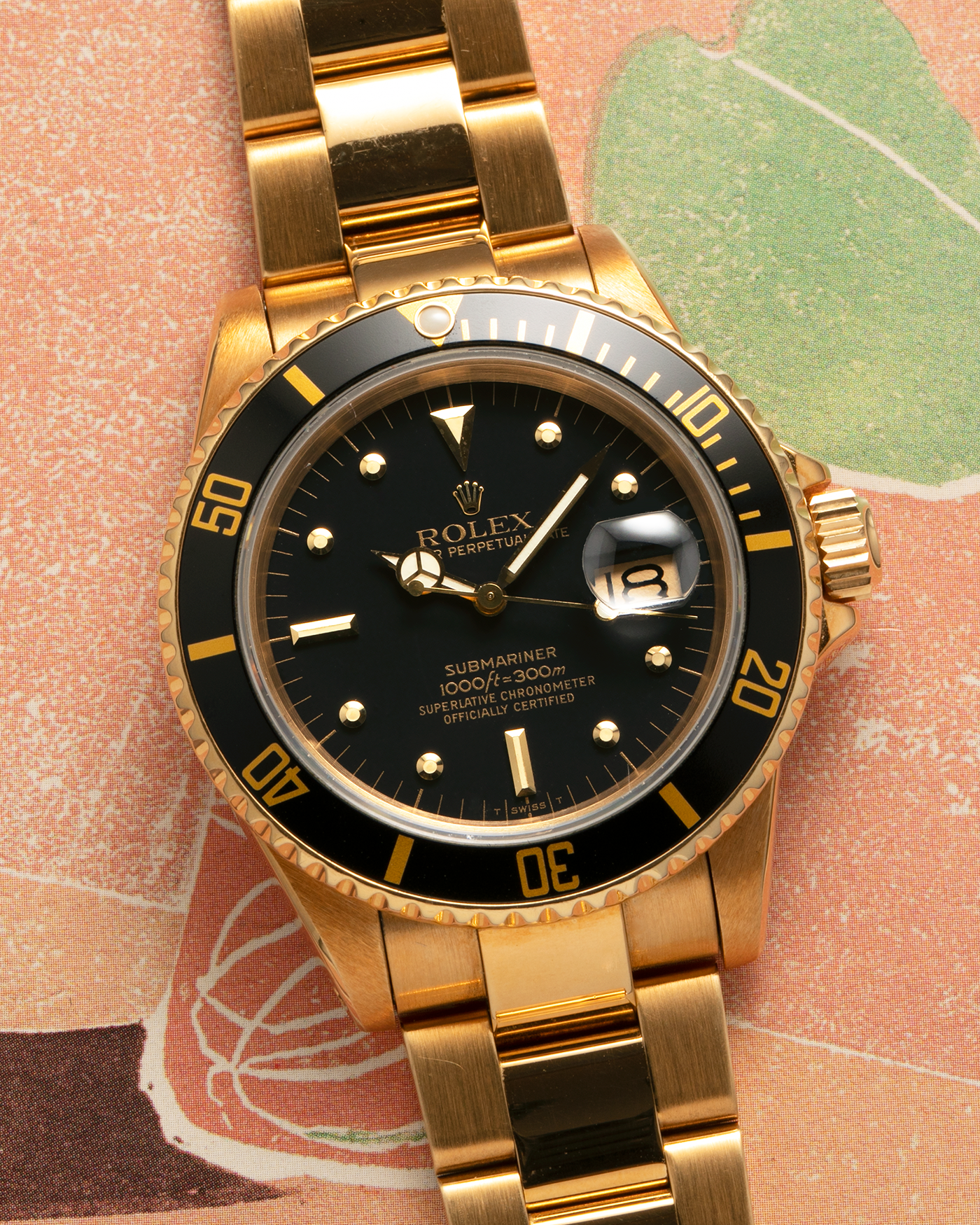 Brand: Rolex
Year: 1984
Model: Submariner
Reference Number: 16808
Serial Number: 838XXXX
Material: 18-carat Yellow Gold
Movement: Rolex Cal. 3035, Self-Winding
Case Dimensions: 40mm x 12.5mm (Lug-to-Lug 47.5mm)
Lug Width: 20mm
Bracelet: Rolex 92908 Oyster Bracelet in 18-carat Yellow Gold With Signed Deployant Clasp with Dive Extension