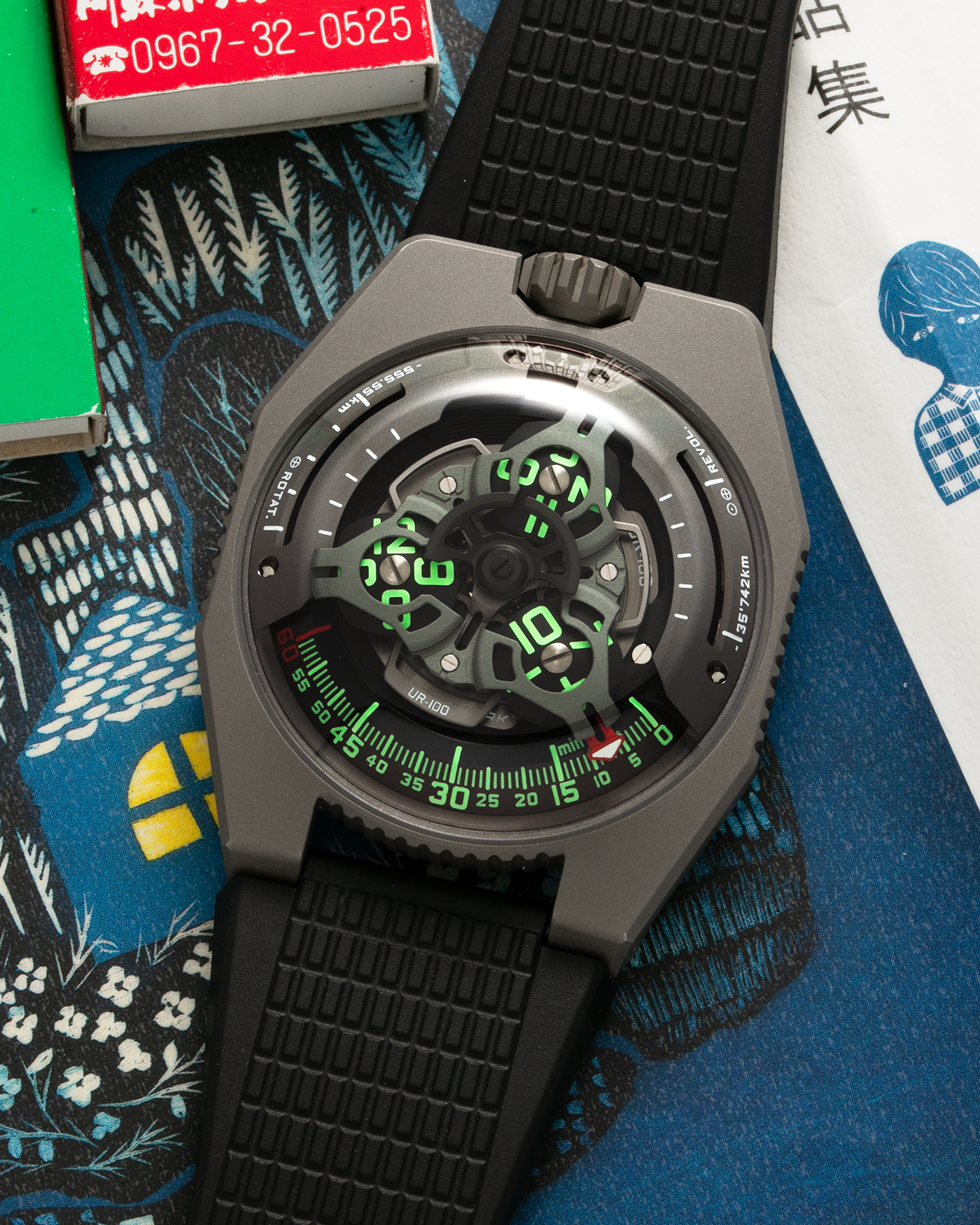 Brand: Urwerk Year: 2020 Model: UR100 GunMetal, Limited Edition of 25 Pieces Material: Titanium and Stainless-Steel Case with GunMetal PVD-Coating, ARCAP Alloy (Blend of Nickle, Copper, Cobalt and Zinc) Movement Carousell System Movement: Urwerk Cal. 12.01, Self-Winding Case Dimensions: 41mm x 14mm Strap: Urwerk Proprietary Black Rubber Strap with Signed Deployant Buckle, with additional Urwerk Proprietary Black Textile Strap