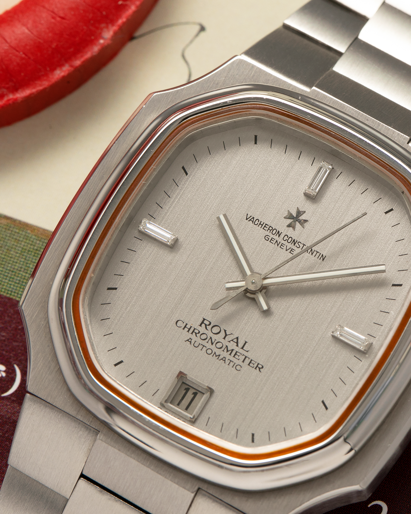 Brand: Vacheron Constantin Year: Mid-1970s Model: Chronometer Royal ‘Diamonds’ Reference Number: 2215 Material: Stainless Steel Case, White Gold Baton Hands, Factory Applied Baguette Diamonds at 3, 9, and 12 o’clock Movement: Vacheron Constantin Cal. 1096, Self-Winding Case Dimensions: 37mm x 10.3mm Bracelet: Vacheron Constantin Stainless Steel Integrated Three-Link Bracelet with Maltese Signed Clasp