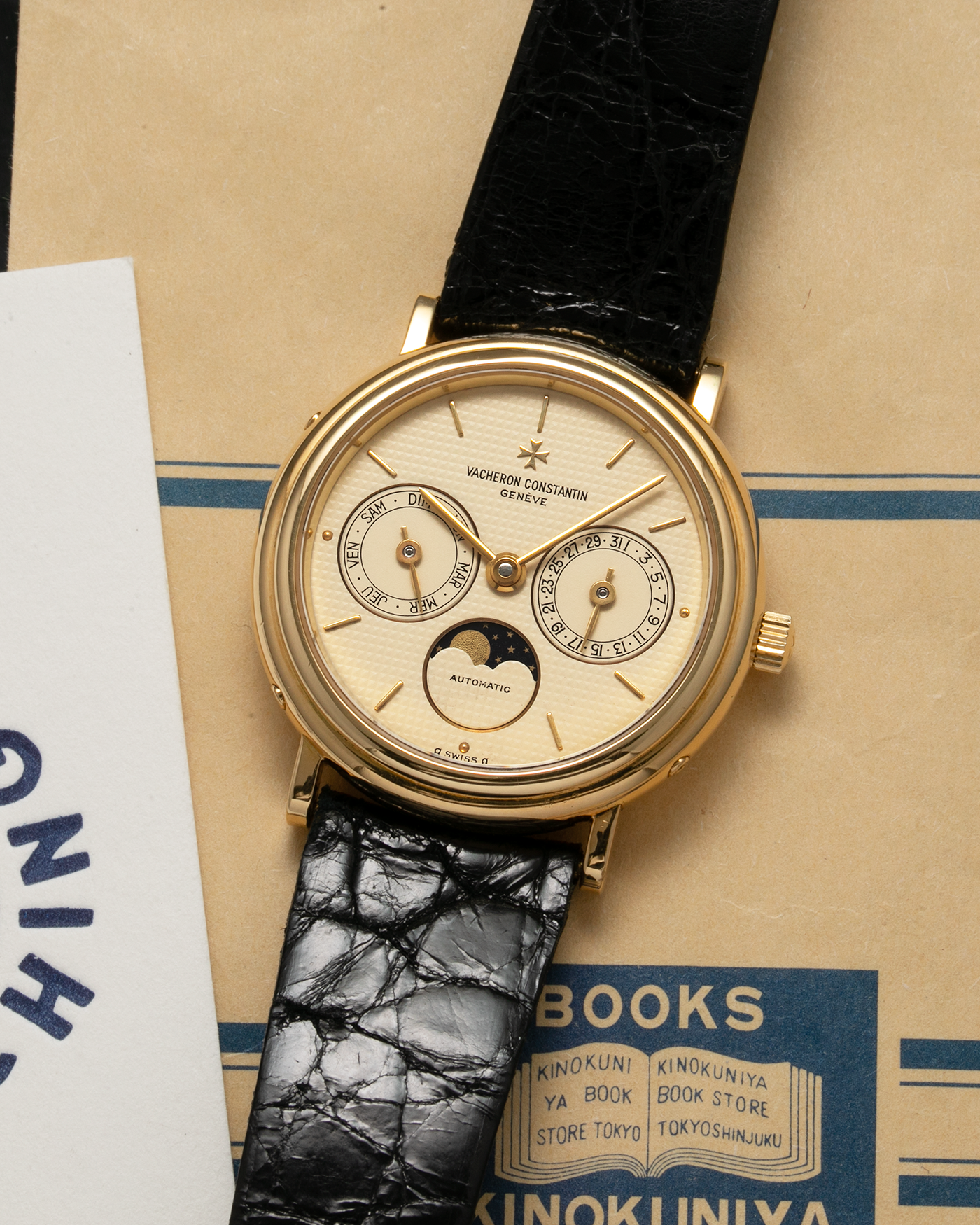 Brand: Vacheron Constantin Year: 1990’s Model: Day-Date Moonphase Reference Number: 46009 Material: 18-carat Yellow Gold Movement: Vacheron Constantin Cal. 1126 QS, Self-Winding Case Diameter: 34mm Bracelet: Vacheron Constantin Black Lizard Leather Strap with Signed 18-carat Yellow Gold Tang Buckle
