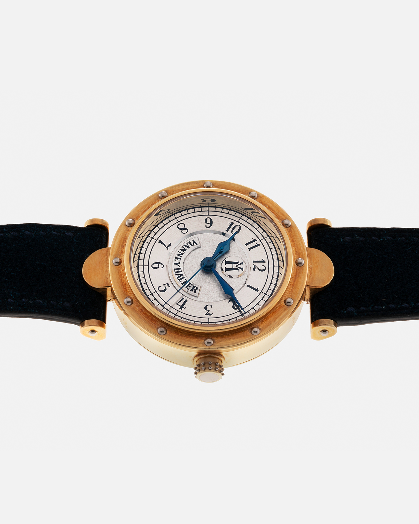 Brand: Vianney Halter Year: 2000’s Model: Classic Material: 18k Yellow Gold Movement: Modified Lemania 8810 with mystery motor Case Diameter: 36mm Bracelet/Strap: Blue Suede strap with Yellow Gold Tang Buckle