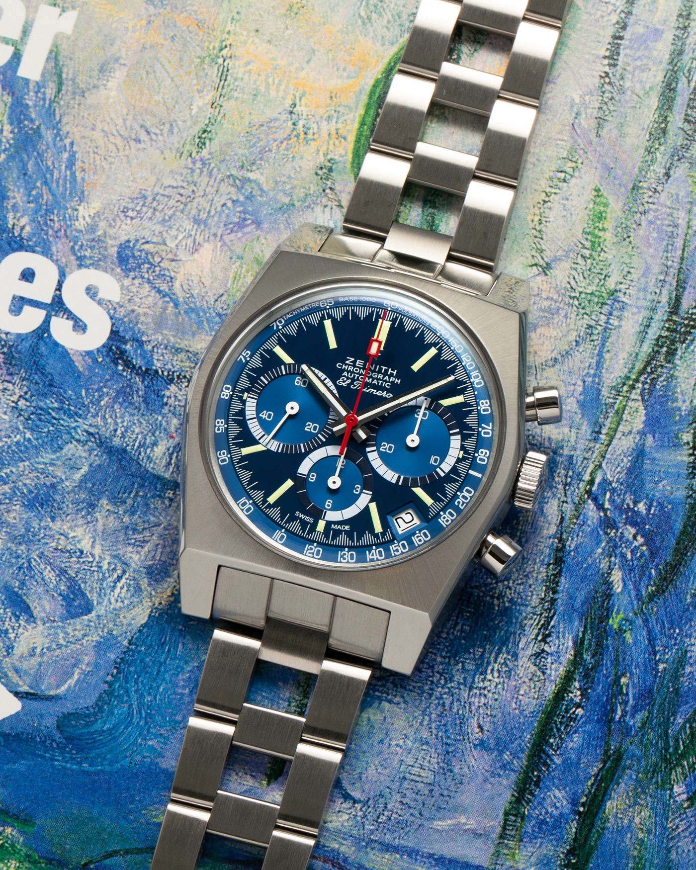 Brand: Zenith
Year: 2020
Model: Zenith x Revolution & The Rake Chronomaster Revival El Primero ‘Cover Girl’, Limited Edition of 100 Pieces
Reference Number: A3818
Material: Stainless Steel
Movement: Zenith El Primero Cal. 400, Self-Winding
Case Diameter: 37 mm x 13mm (Lug-to-Lug 48mm)
Lug Width: 19mm
Bracelet: Gay Frères Ladder-Style Stainless Steel Bracelet with Zenith Signed Clasp, with additional Zenith Beige Grained Calf Leather Strap, and Zenith Navy Suede Perforated Leather Strap